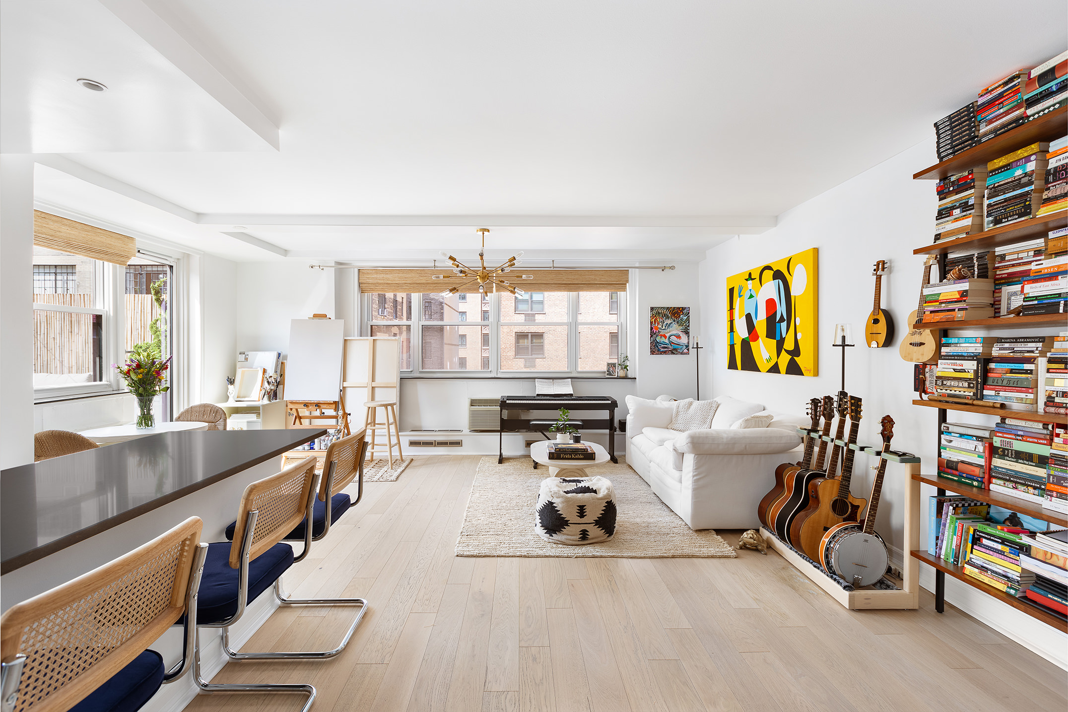 a large white room with a large window and furniture