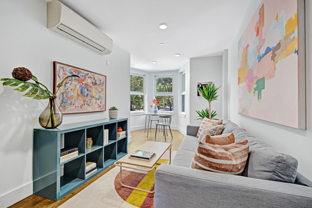 a living room with furniture and book shelf