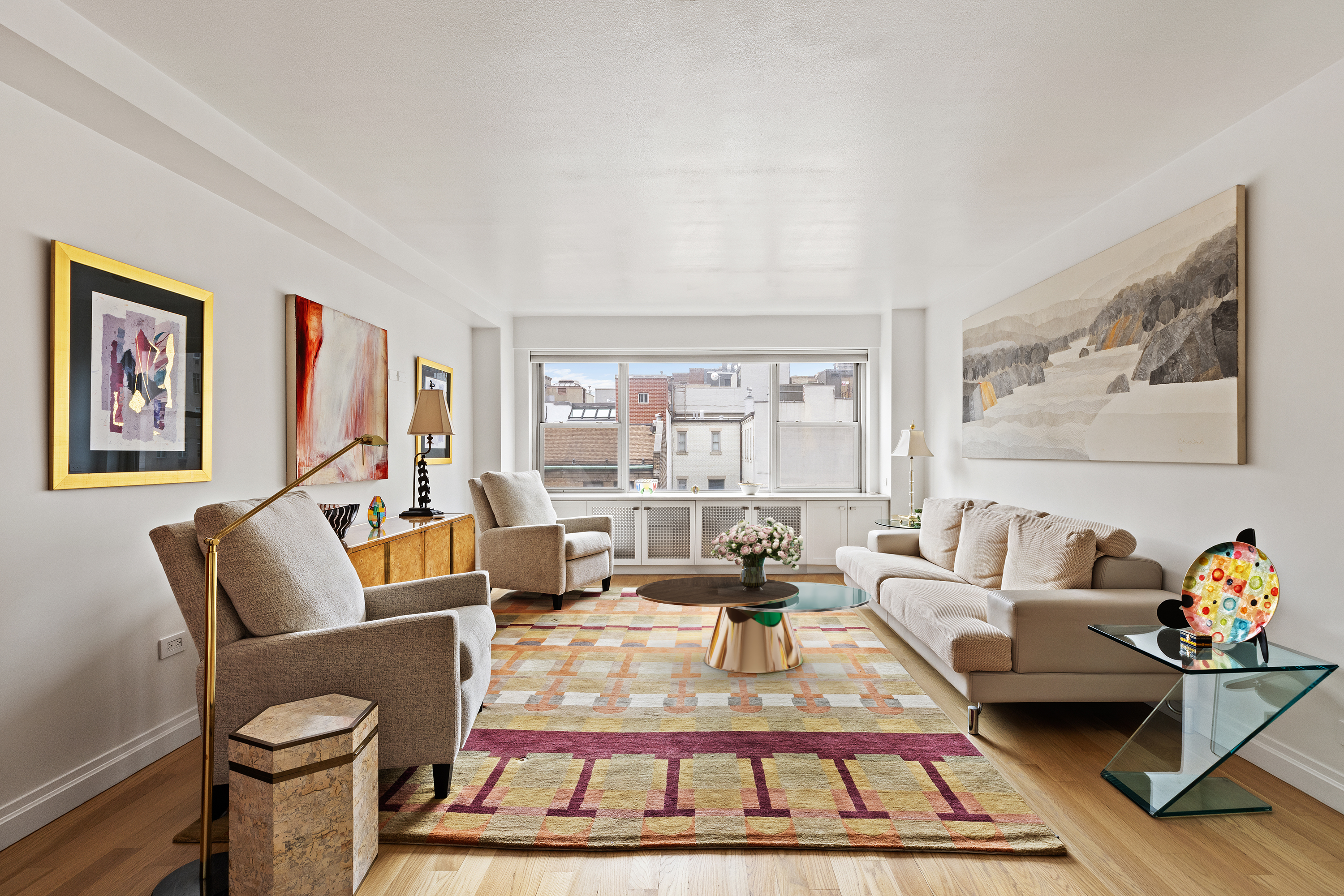 a living room with furniture a rug and a large window