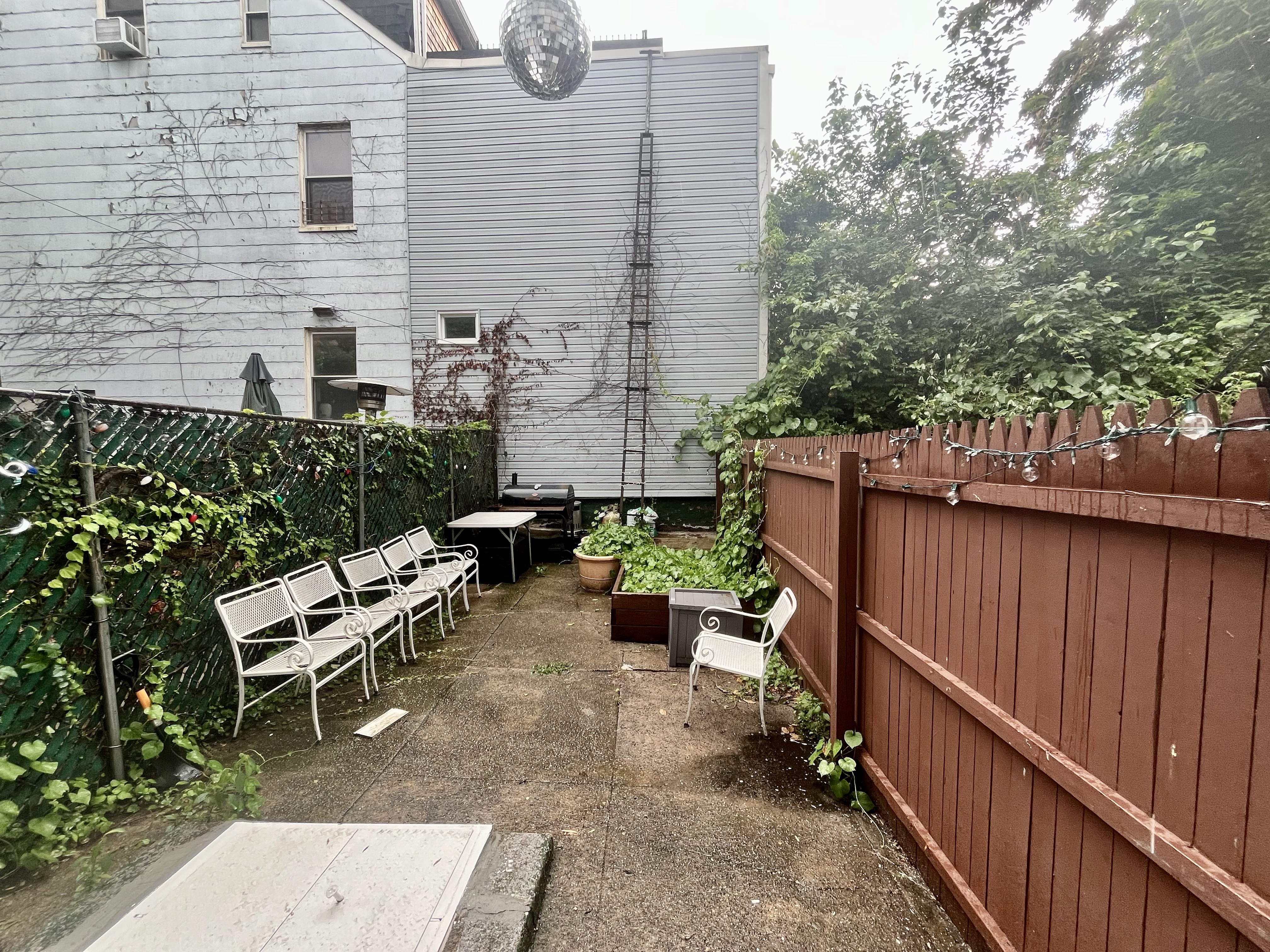 a backyard of a house with outdoor seating