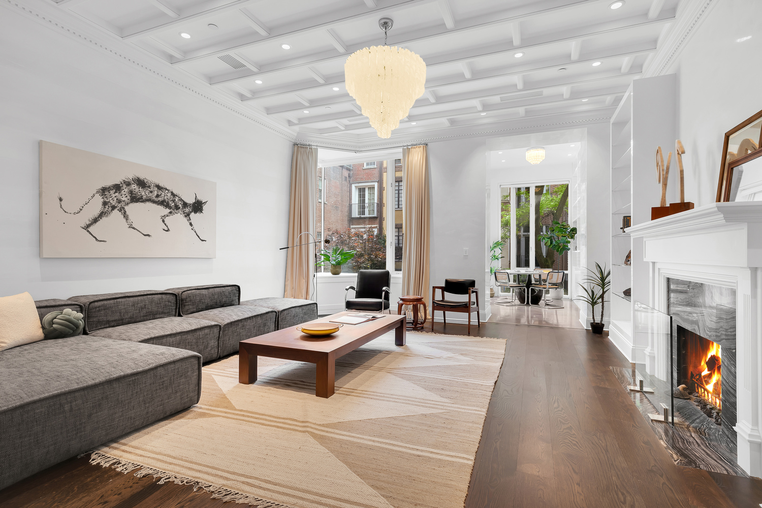 a living room with furniture a fireplace and a chandelier