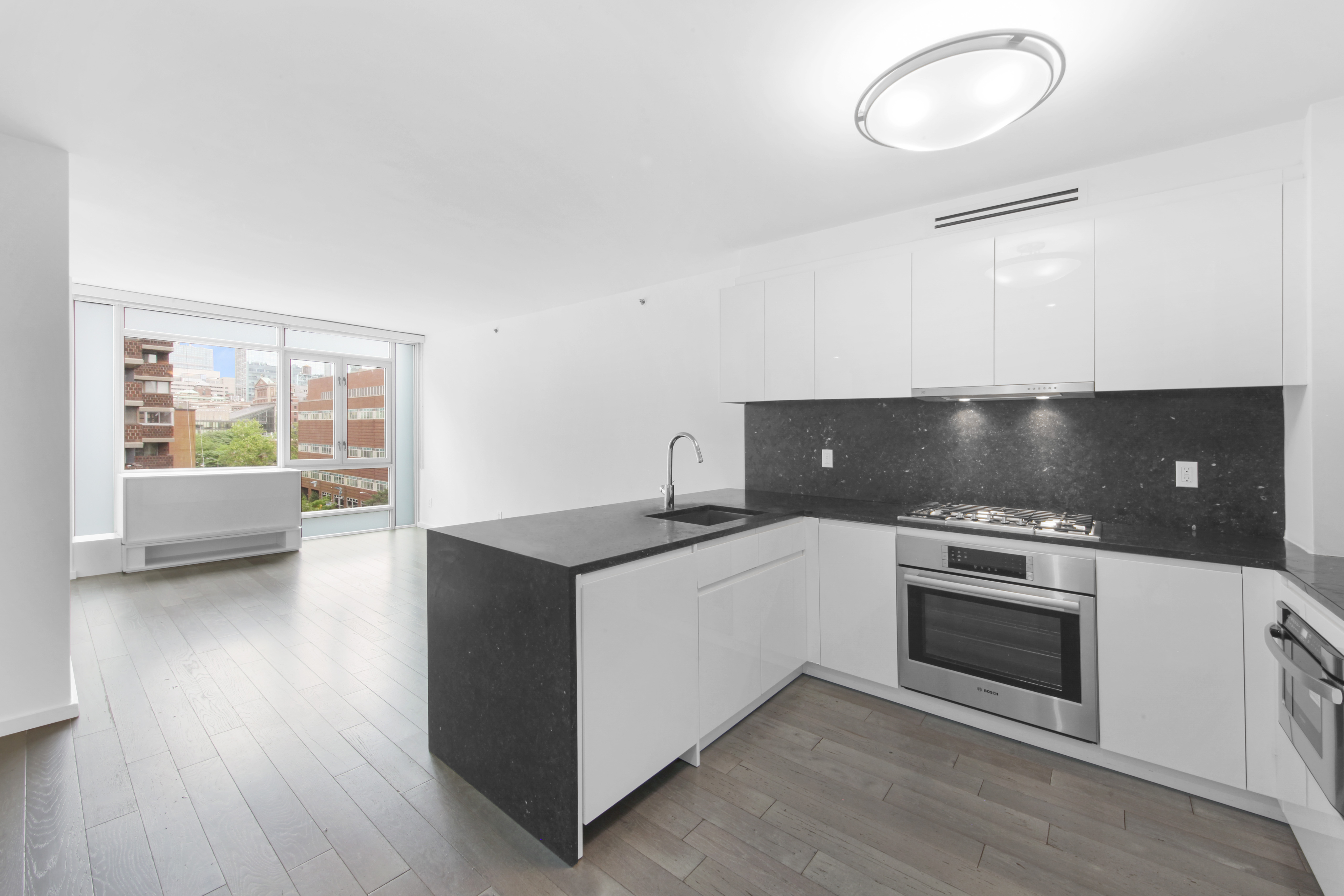 a kitchen with granite countertop a stove and a sink