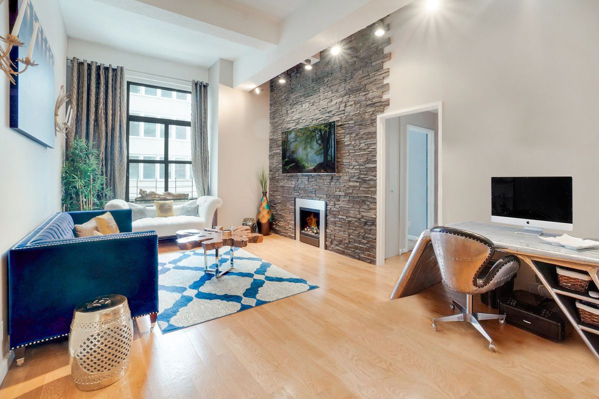 a living room with furniture and a fireplace