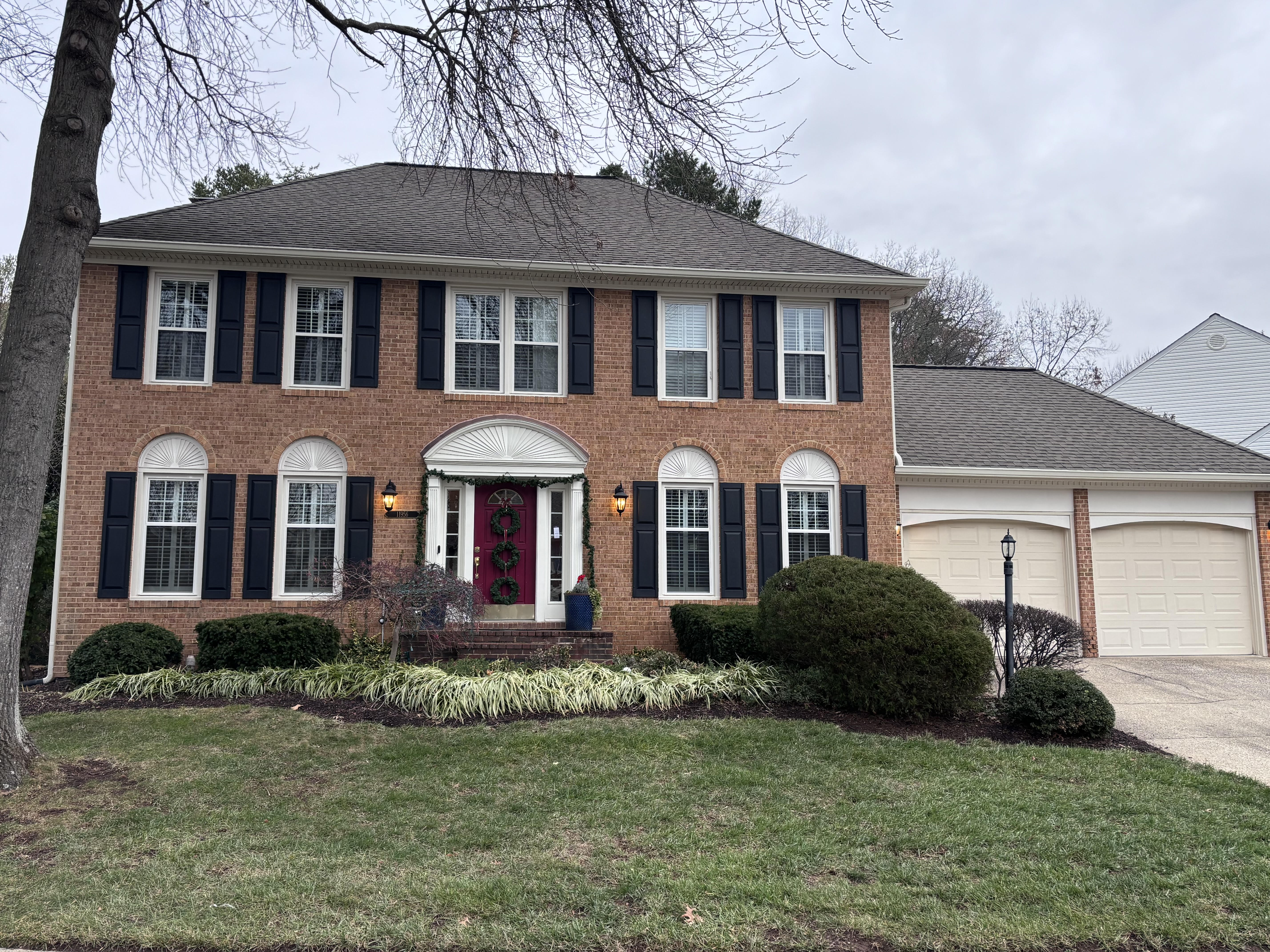 a front view of a house with yard and green space