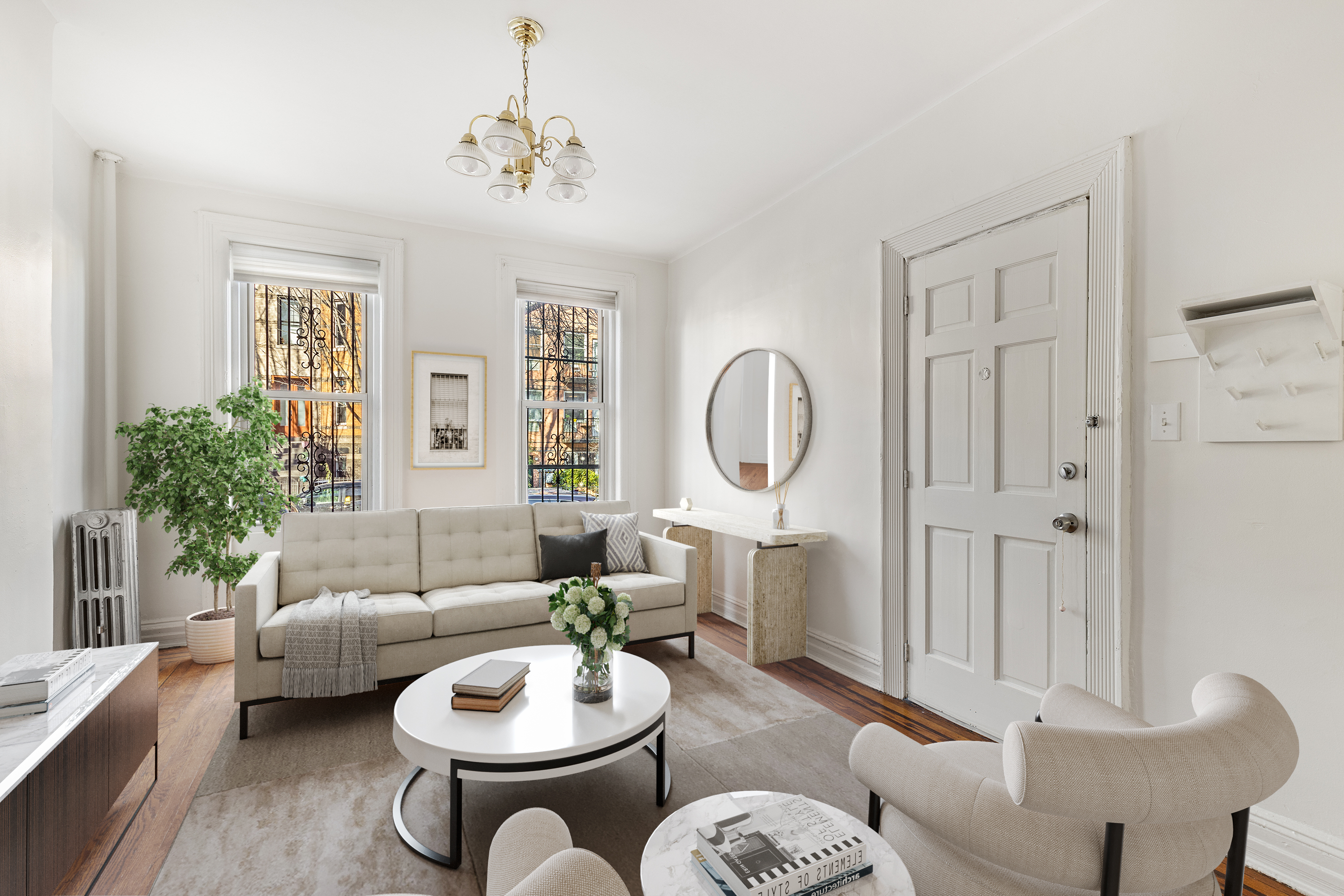 a living room with furniture a chandelier and a window