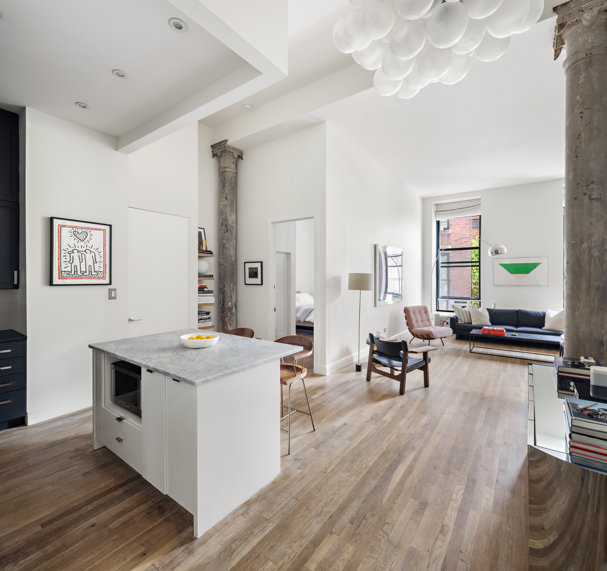 a view of a living room filled with furniture and wooden floor