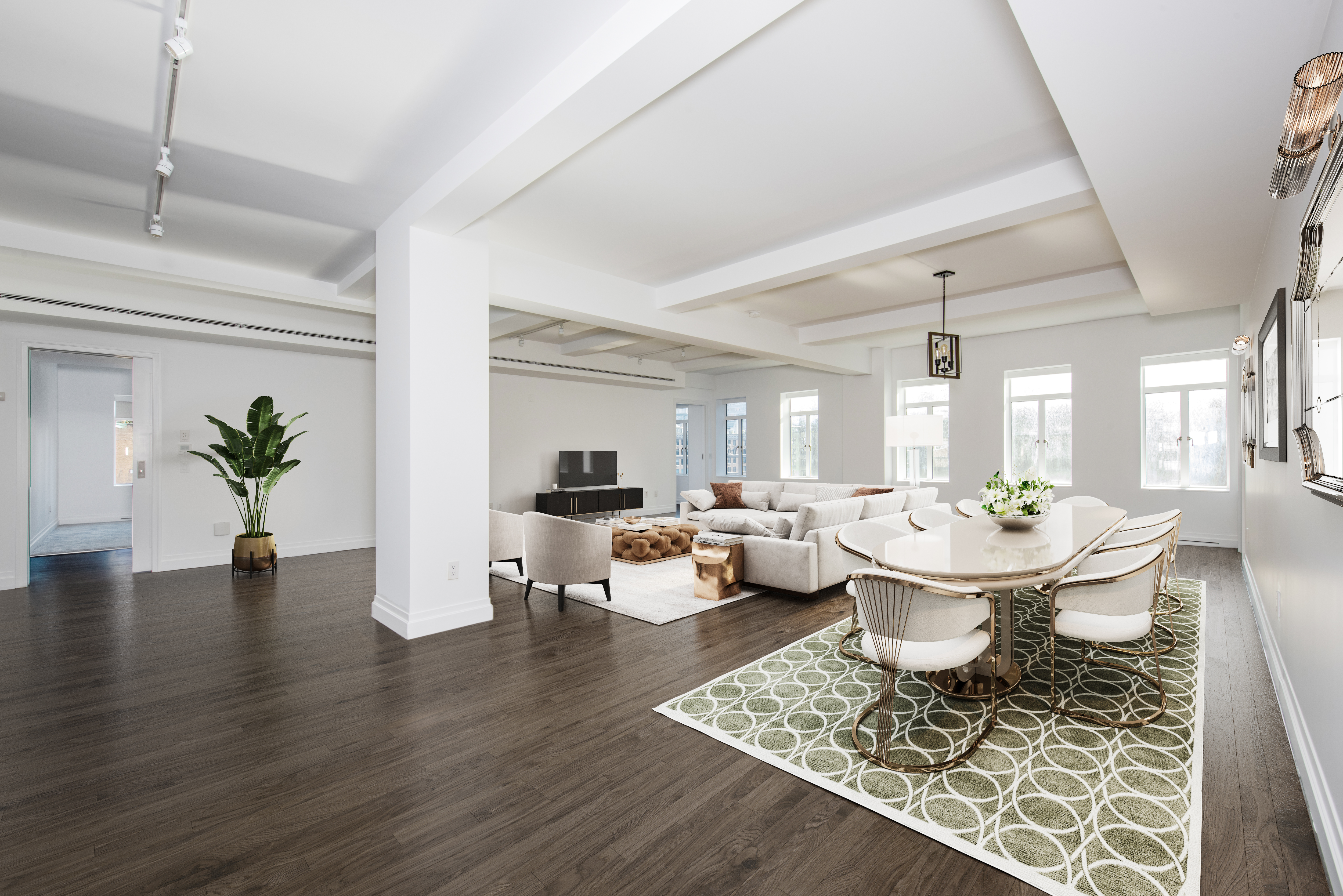 a living room with dining room and wooden floor