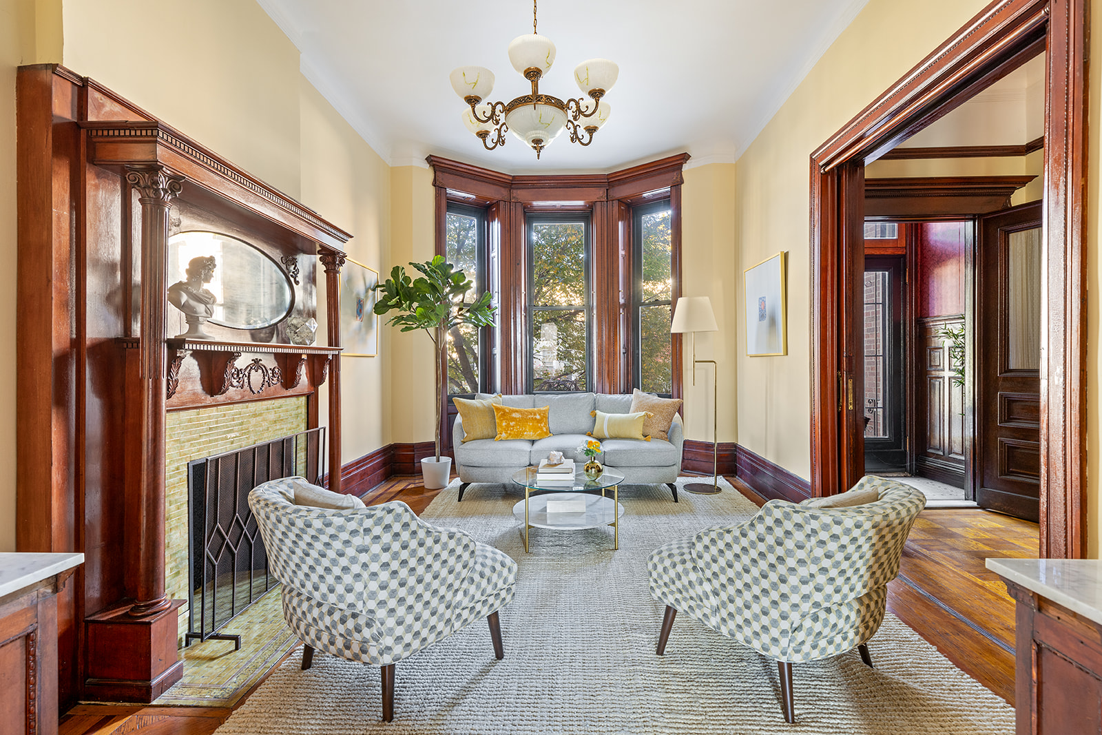 a living room with patio furniture and a large window