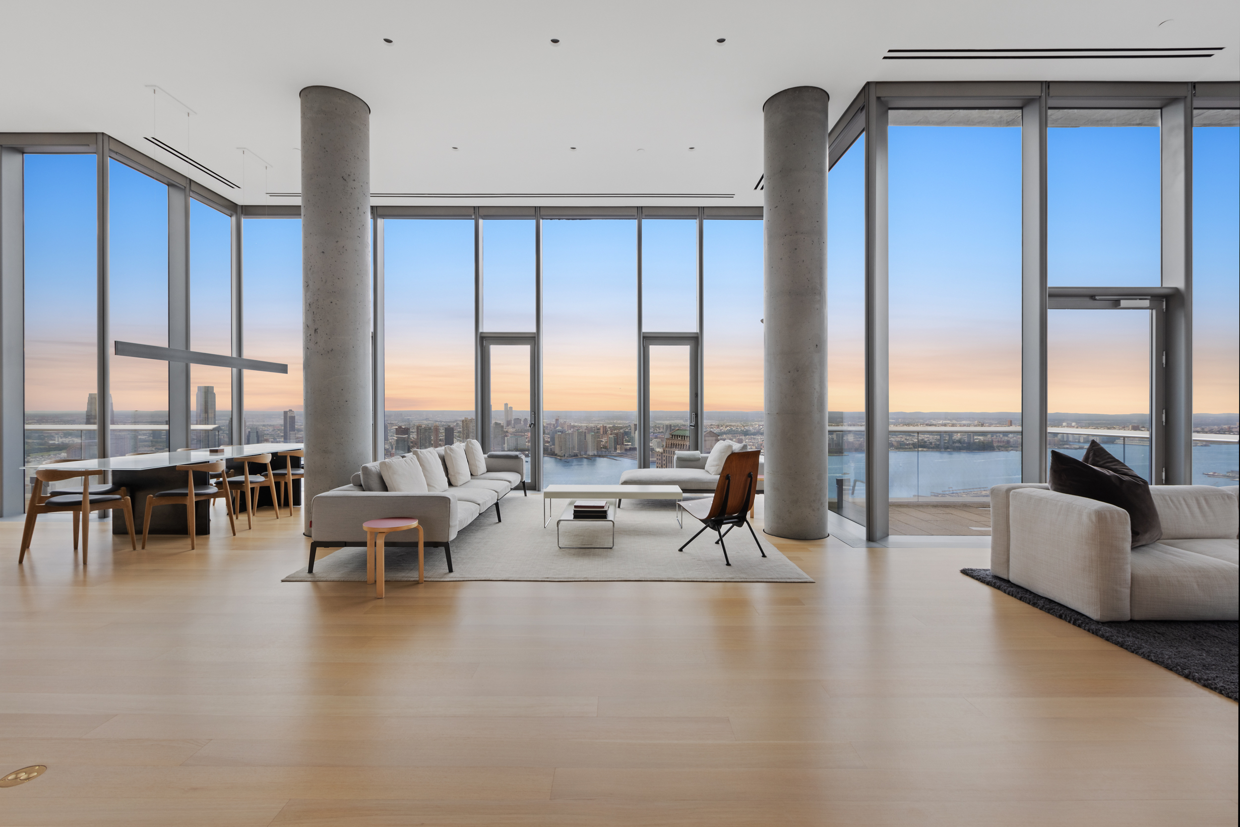 a living room with furniture and floor to ceiling window