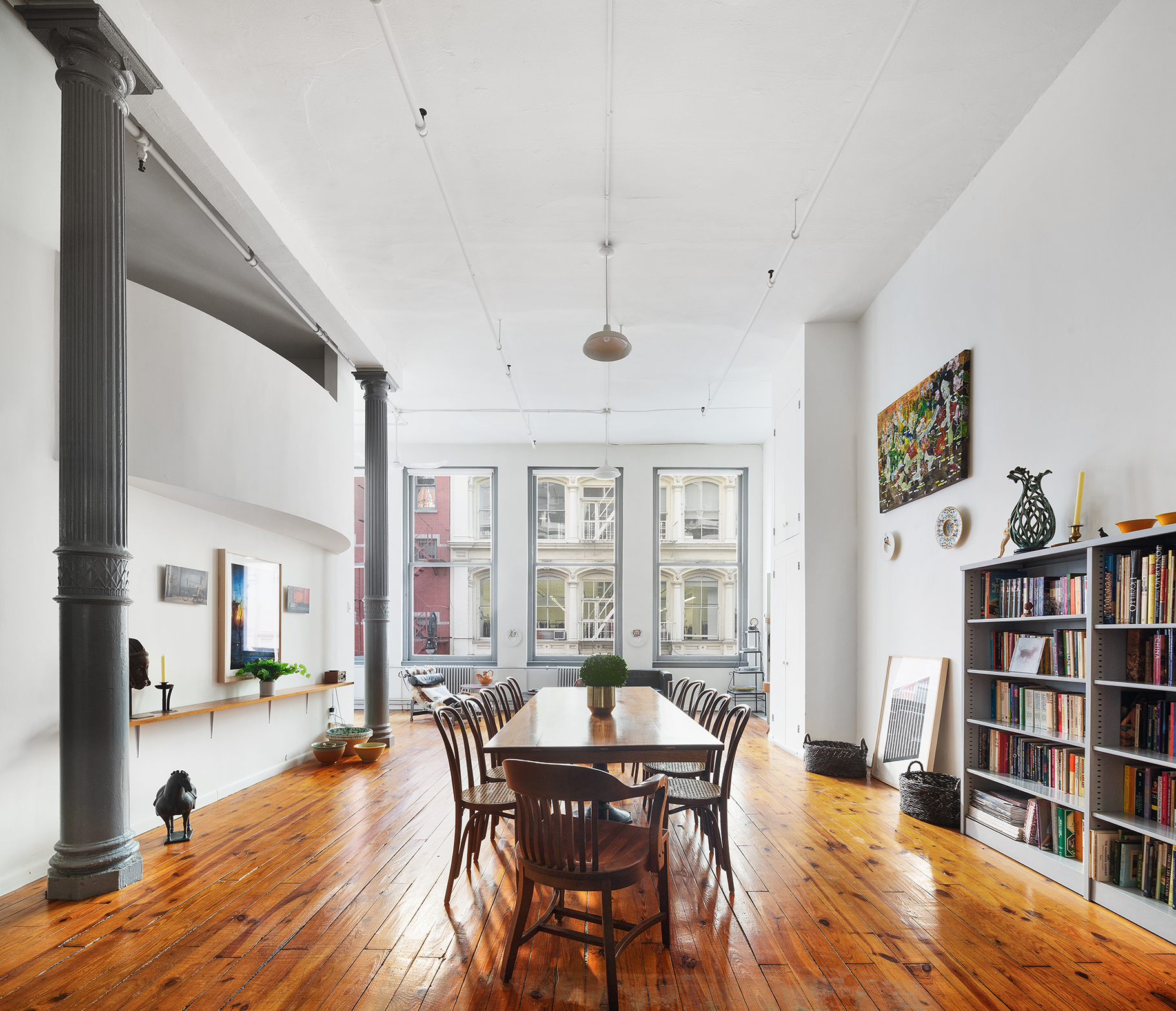 a view of a dining room with furniture and a book shelf