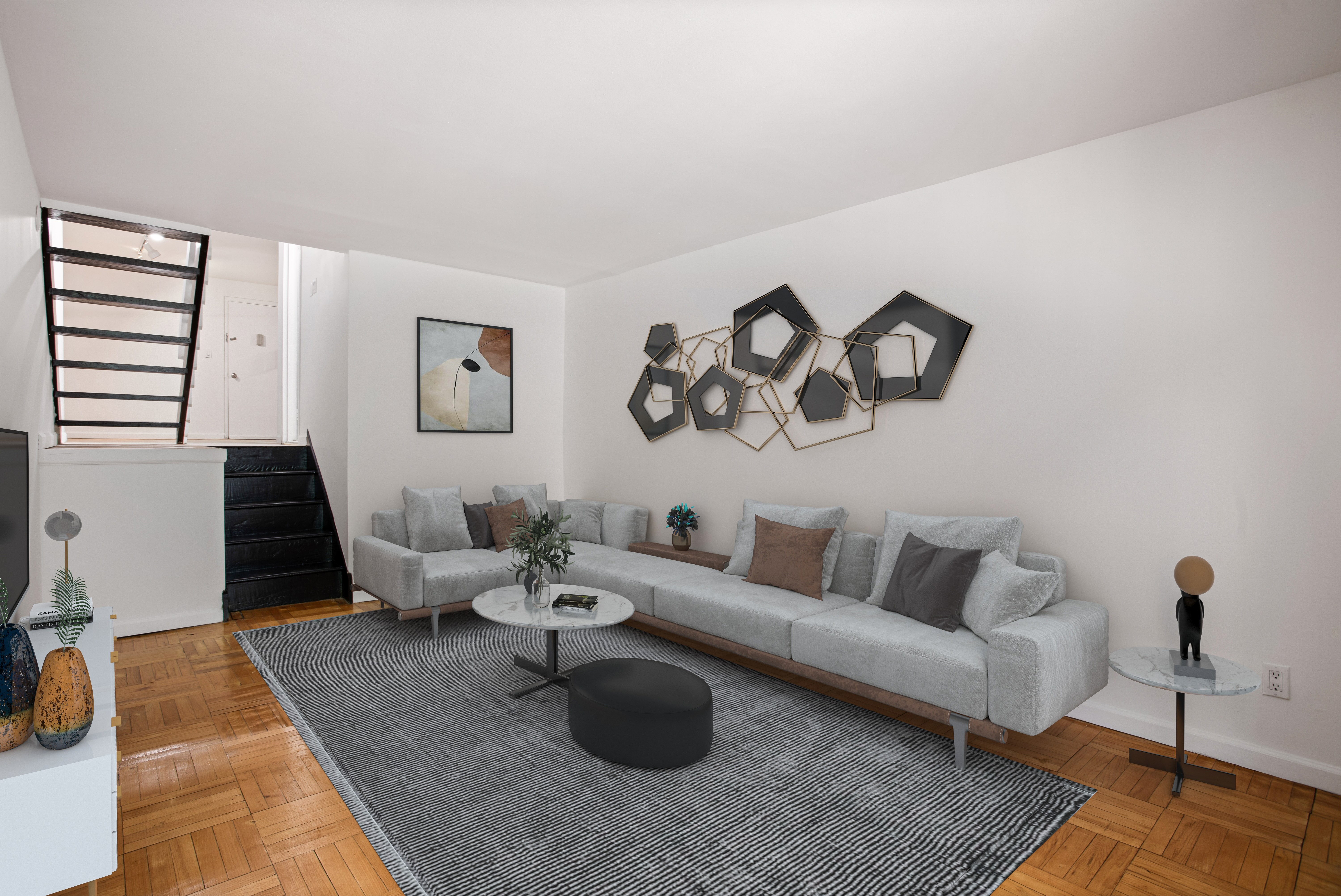 a living room with furniture and wooden floor