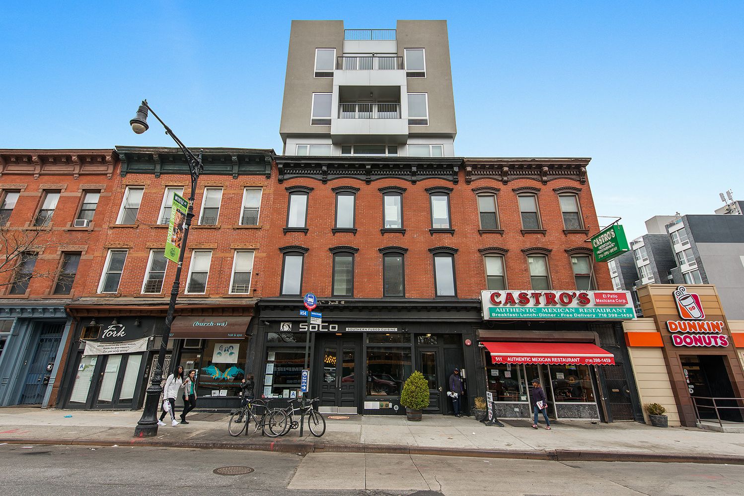 a front view of a building with retail shops