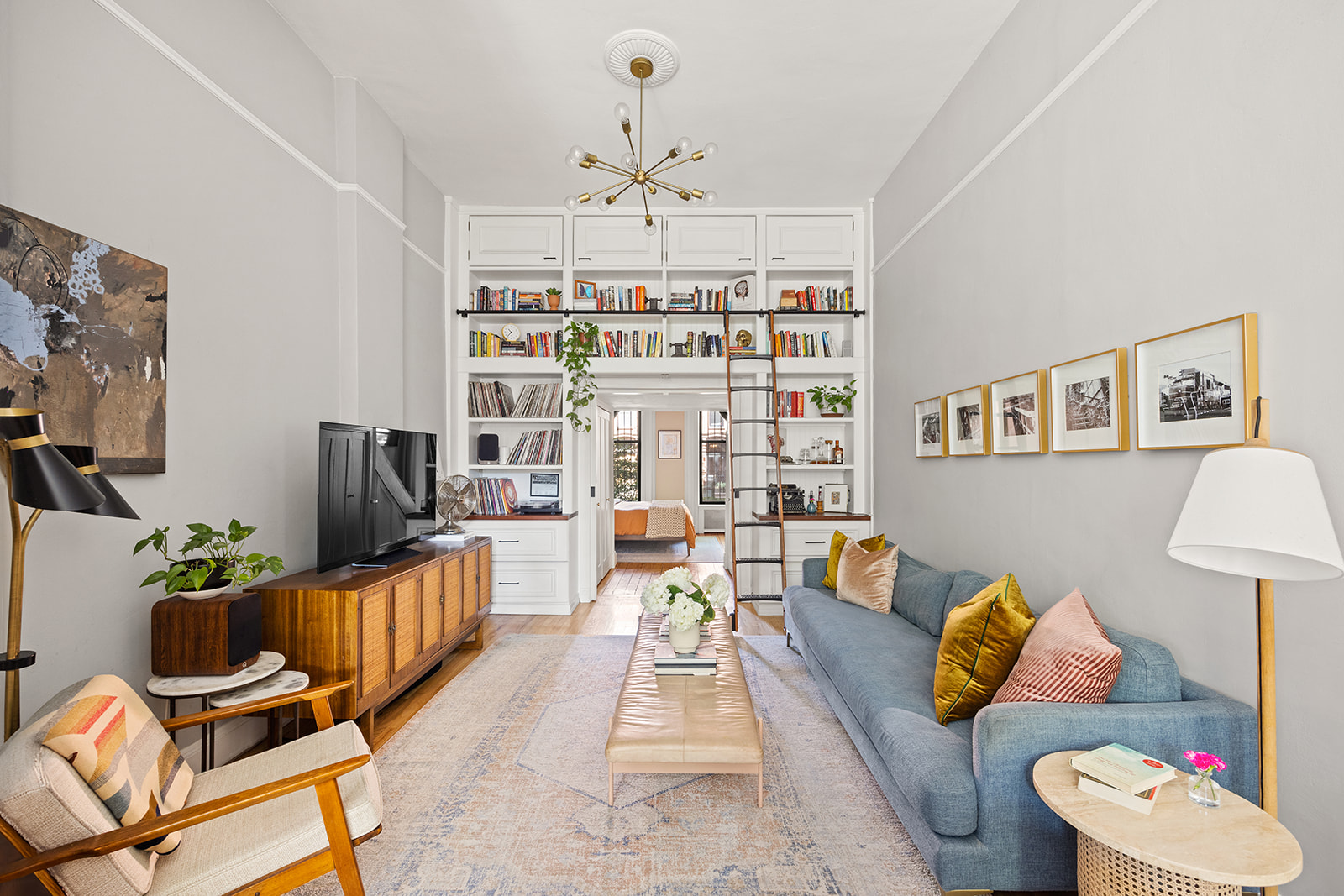 a living room with furniture and a chandelier