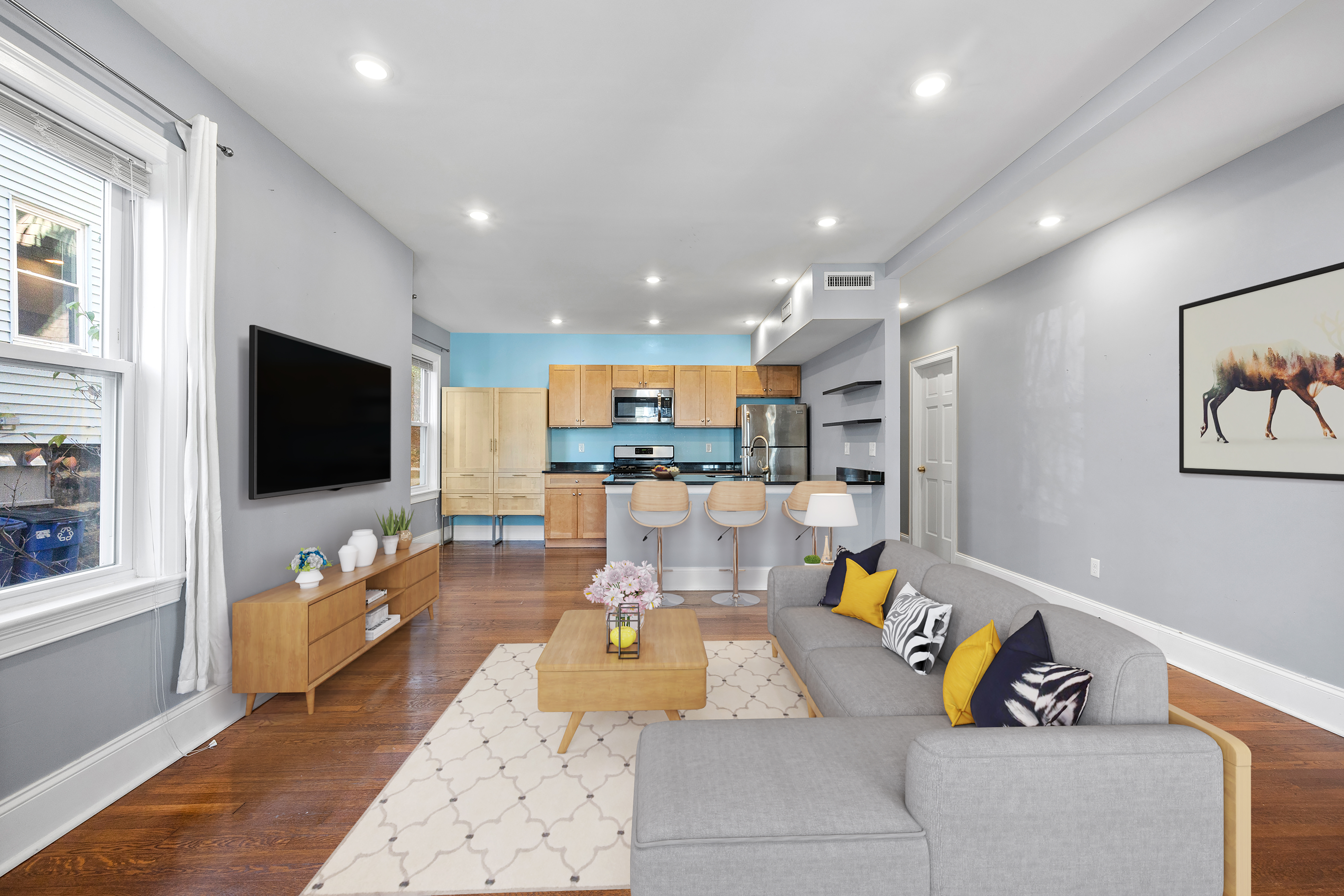 a living room with furniture and a flat screen tv