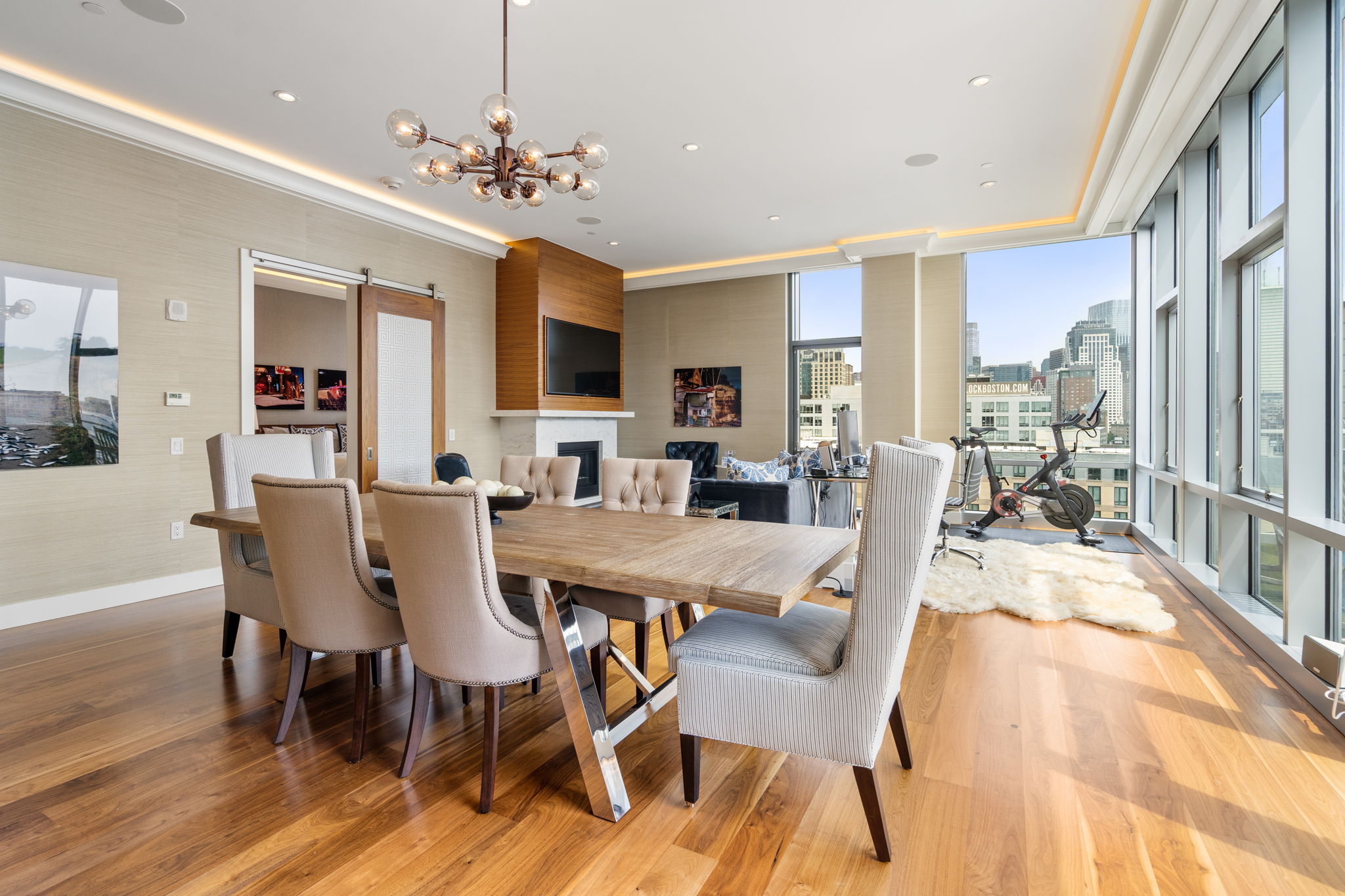 a view of a dining room with furniture a chandelier and wooden floor