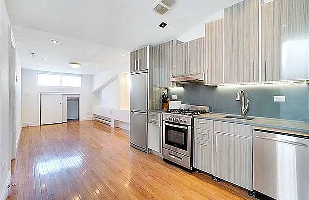 a kitchen with a stove a sink and a refrigerator