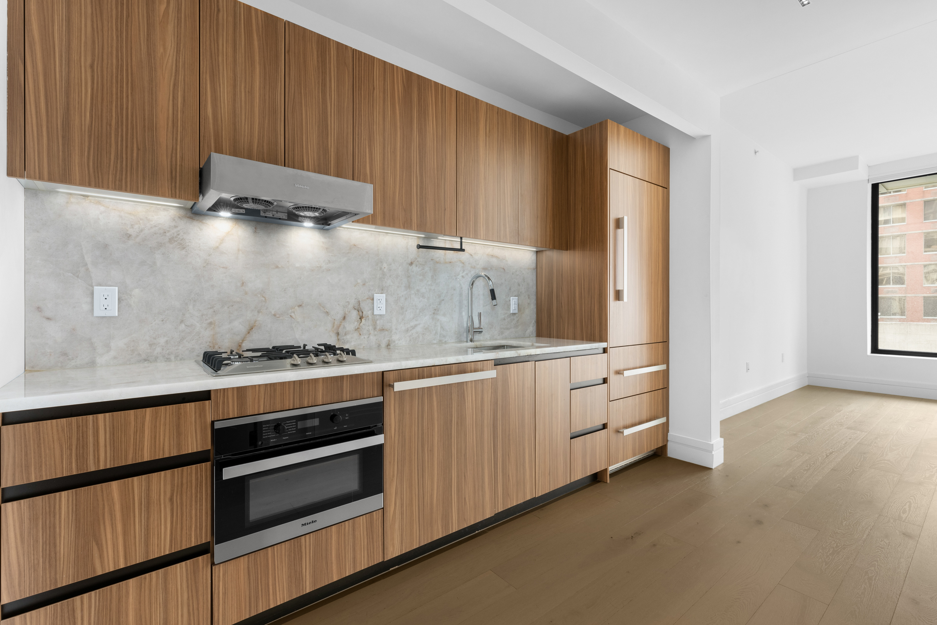 a kitchen with white cabinets and white appliances