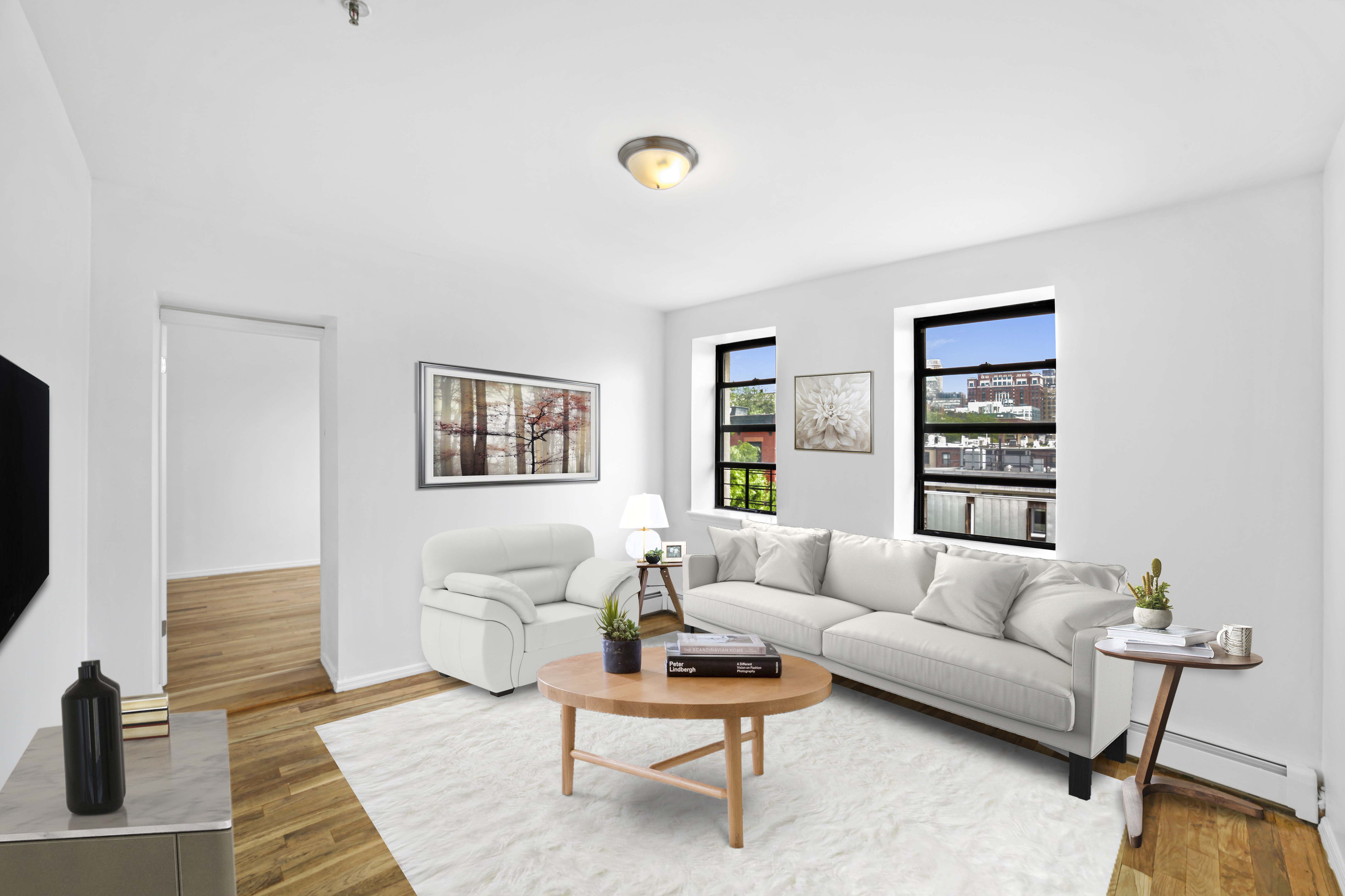 a living room with furniture and a flat screen tv with wooden floor