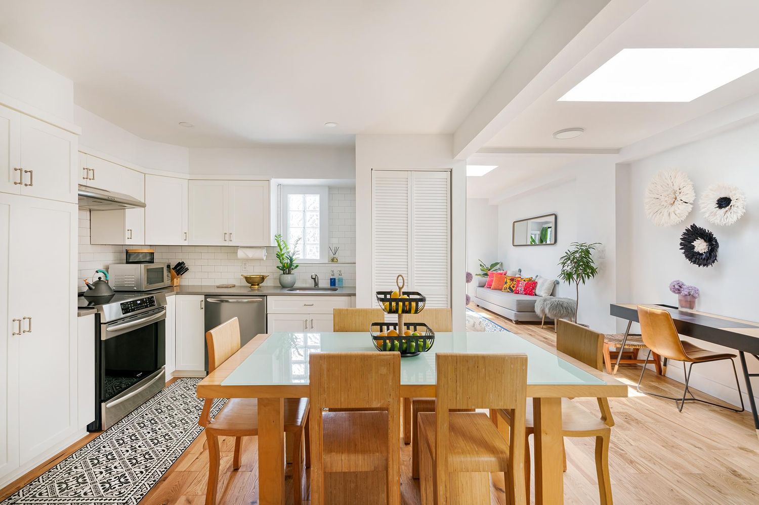 a kitchen with a dining table chairs refrigerator and cabinets