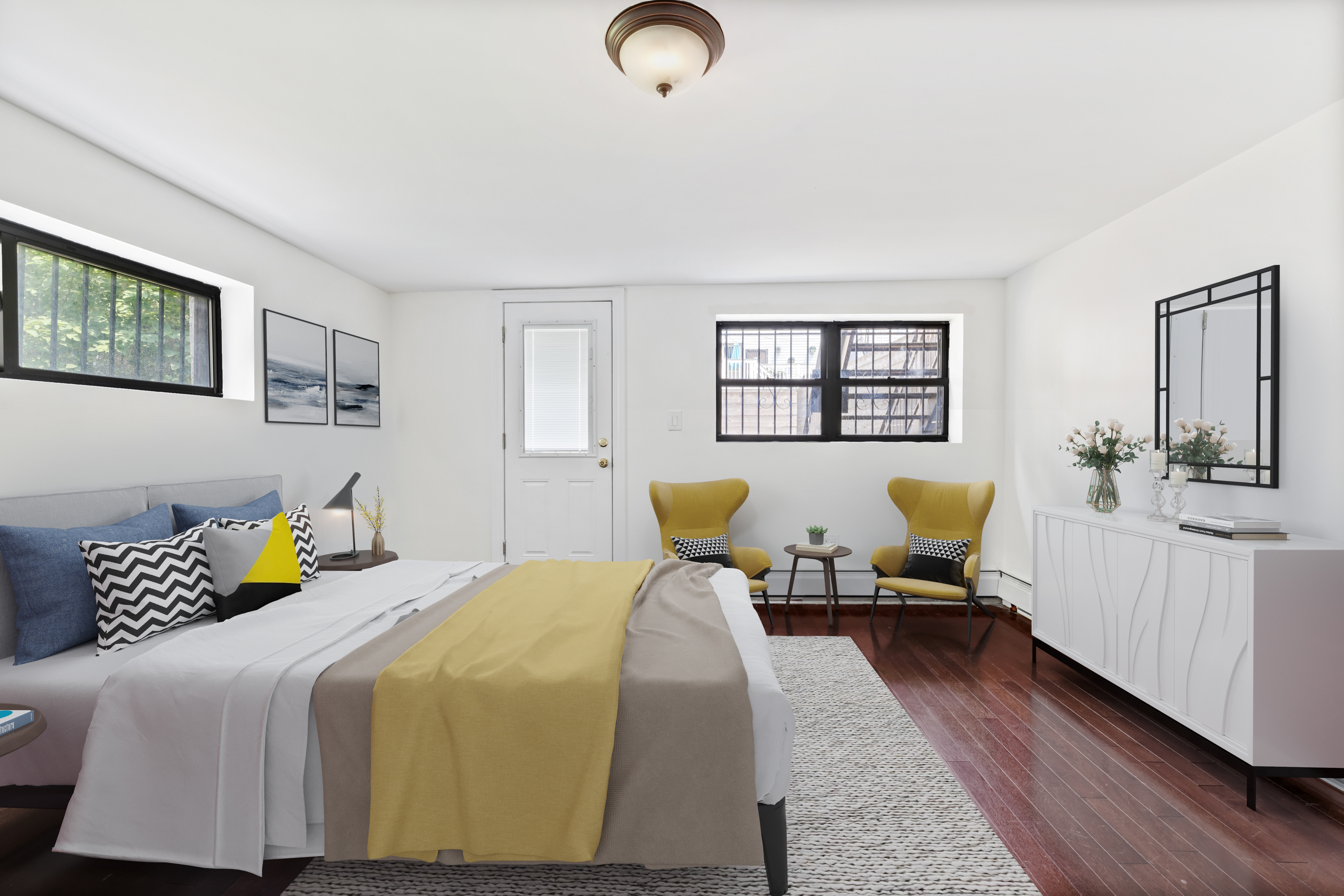 a bedroom with a bed couch and window