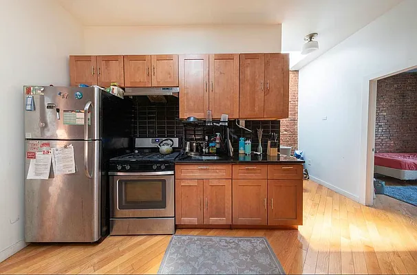 a kitchen with stainless steel appliances granite countertop a refrigerator and a stove