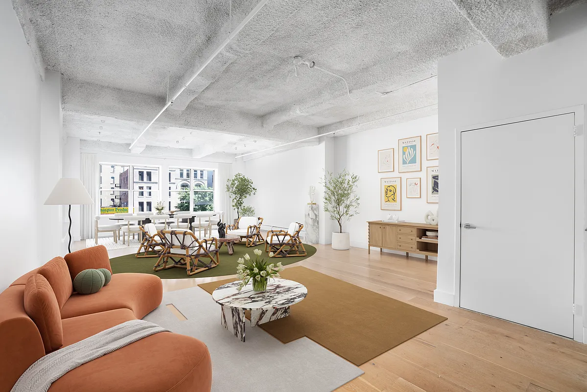 a living room with furniture wooden floor and a table