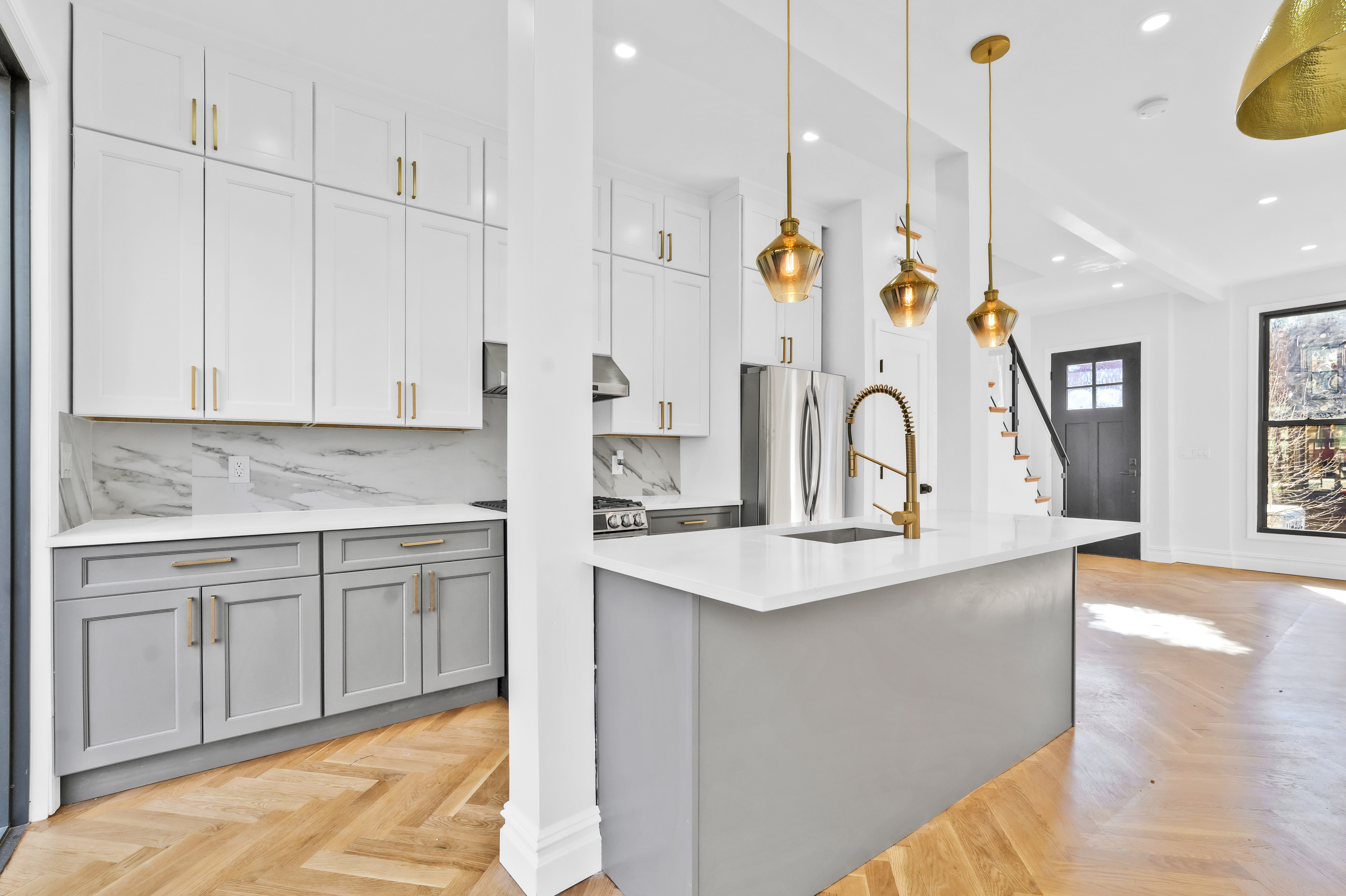 a kitchen with kitchen island a sink appliances and cabinets