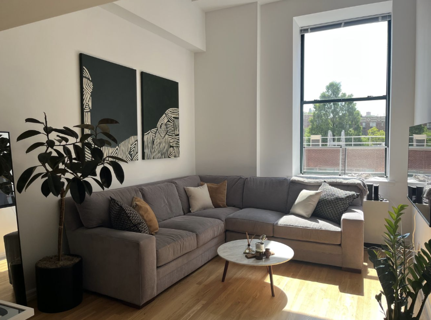 a living room with furniture and a large window