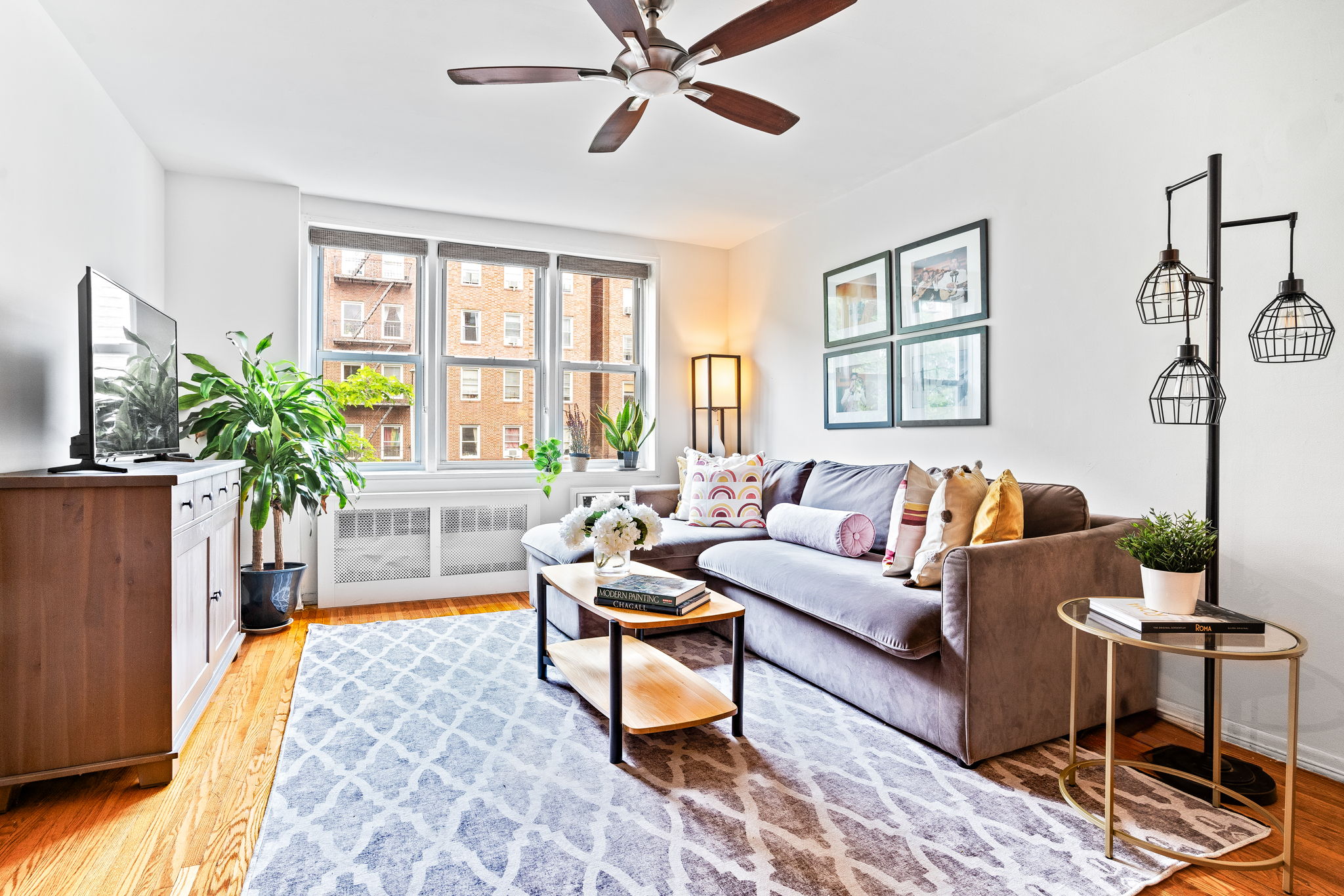 a living room with furniture and a potted plant