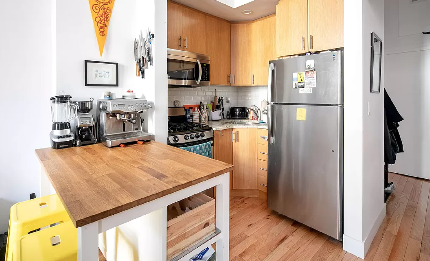 a kitchen with a refrigerator a stove a microwave and cabinets