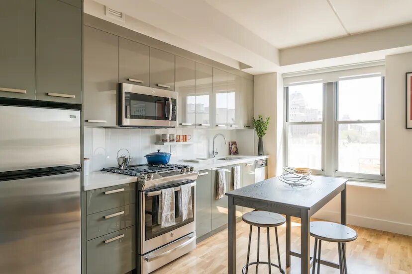 a kitchen with a stove a sink and a microwave