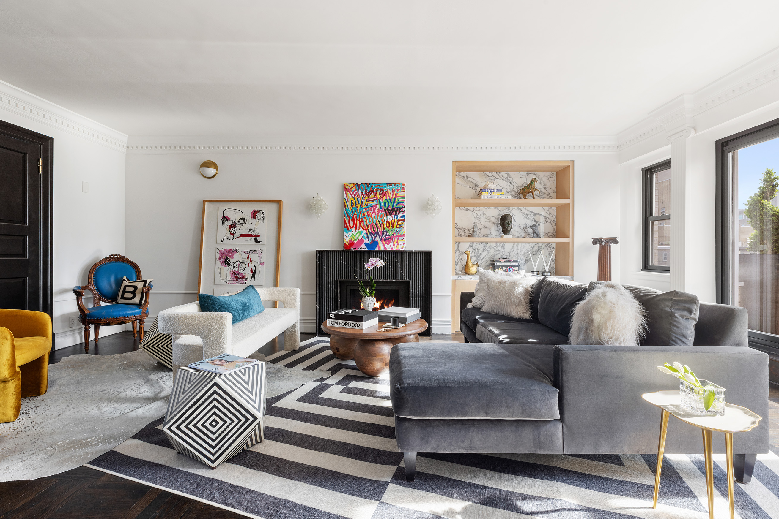 a living room with fireplace furniture and a window