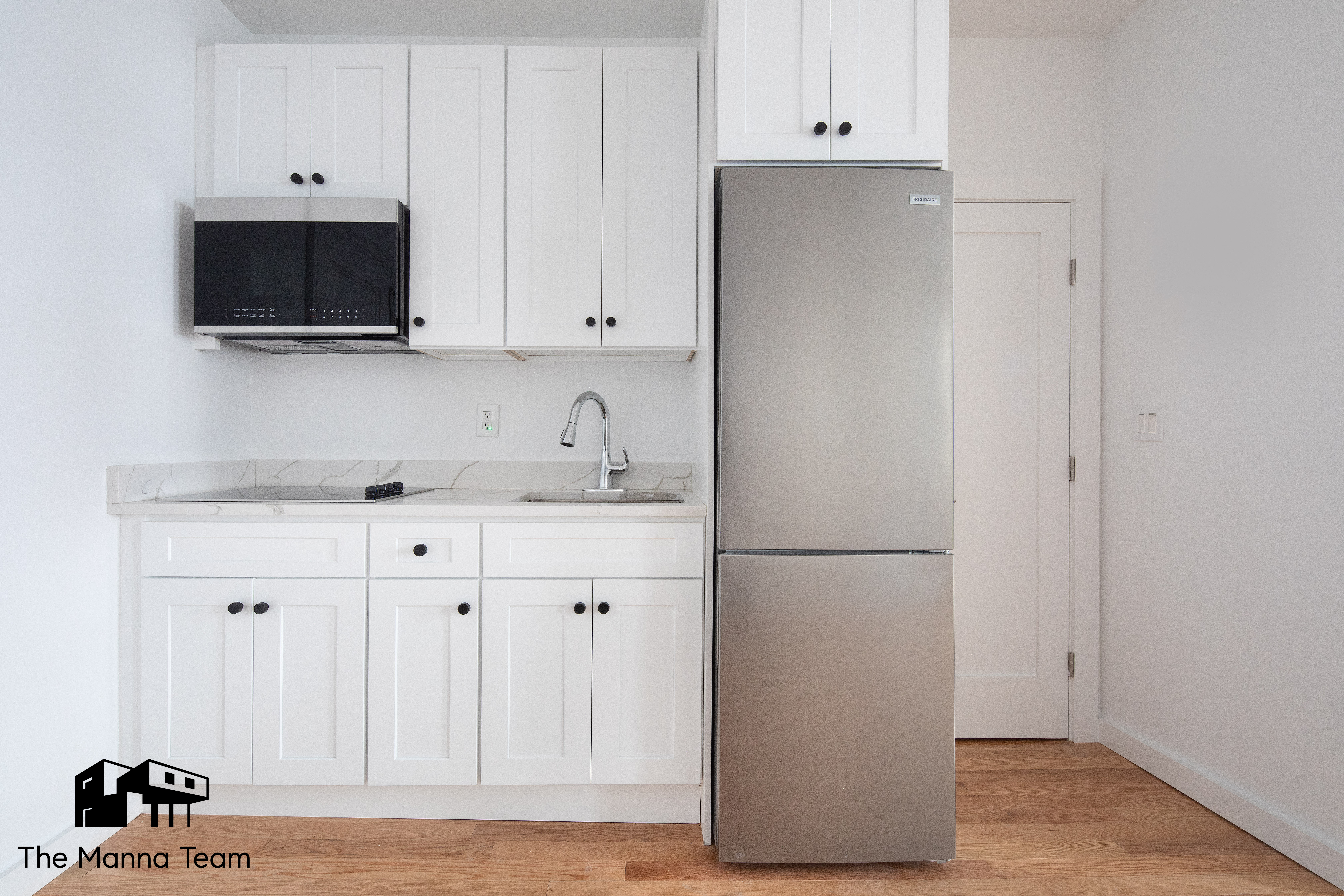 a kitchen with stainless steel appliances white cabinets and a refrigerator