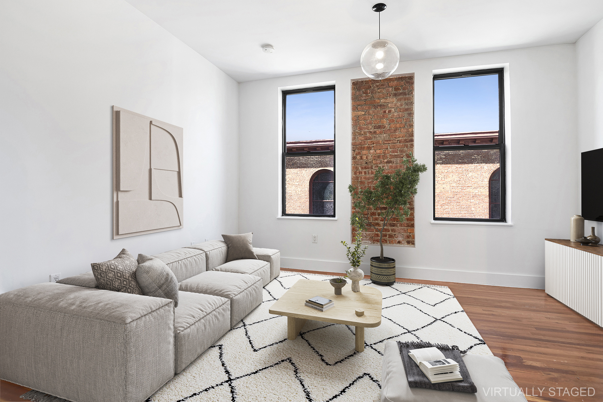 a living room with furniture flowerpot and wooden floor