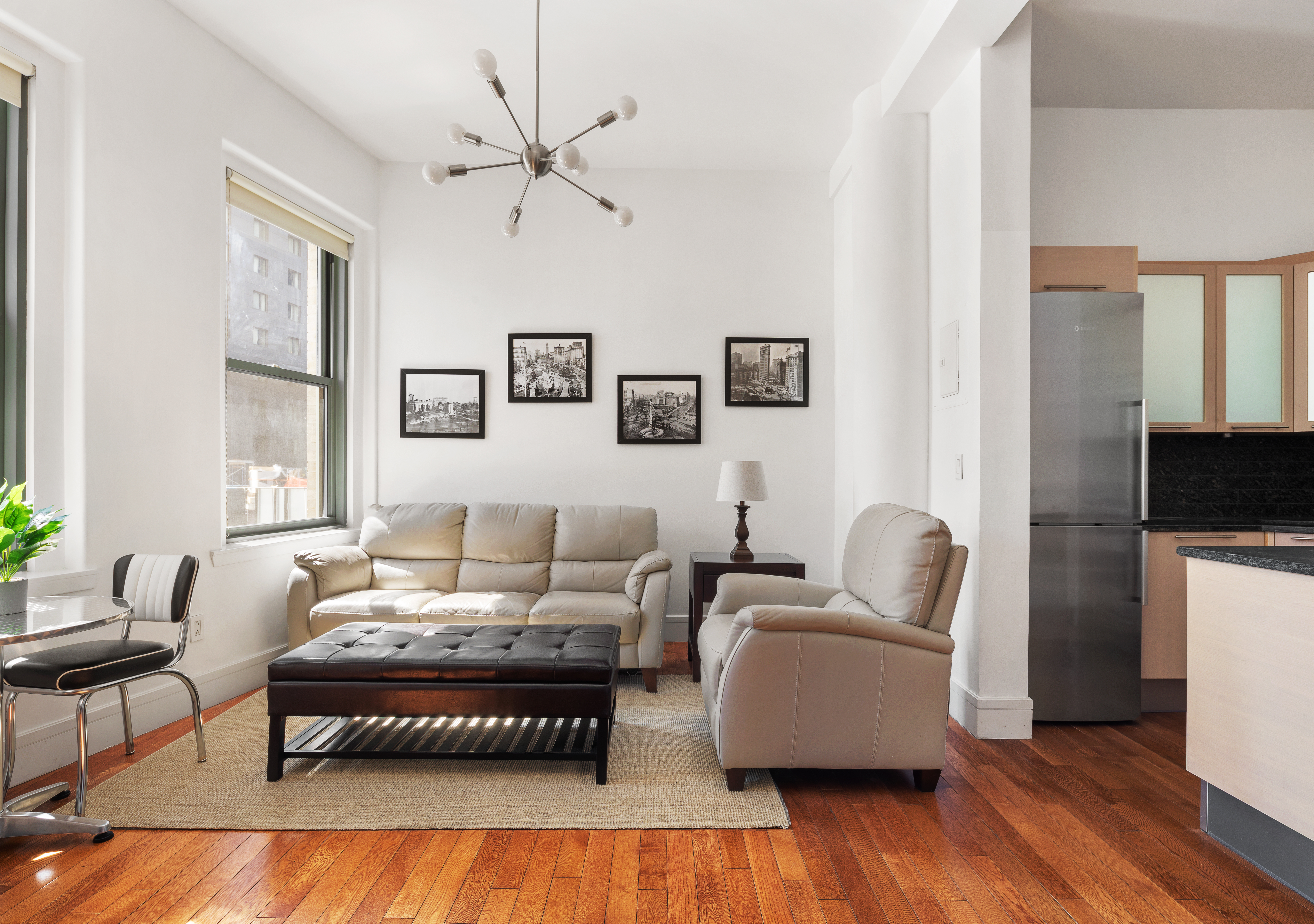 a living room with furniture wooden floor and a flat screen tv