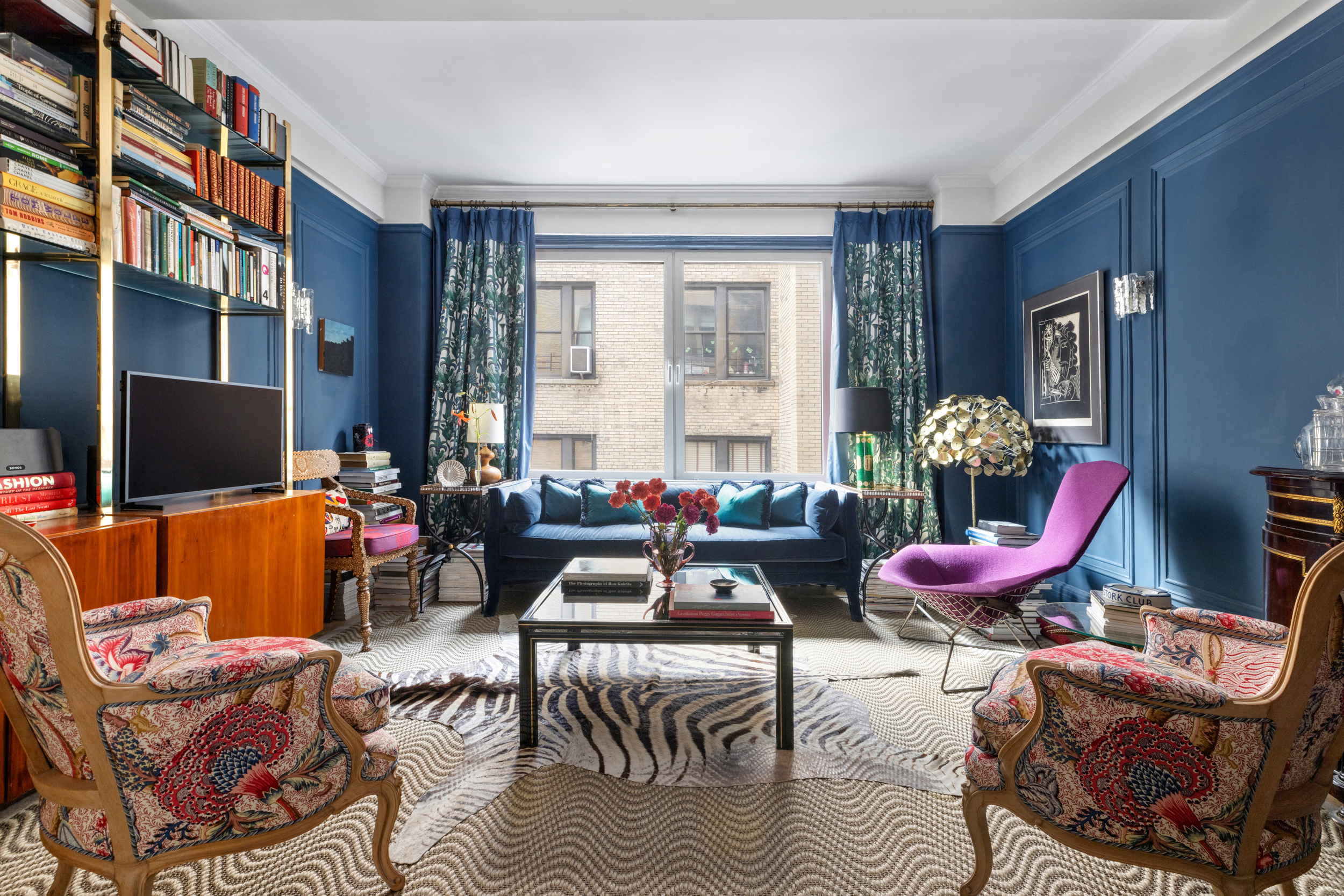 a living room with furniture a couch and a flat screen tv