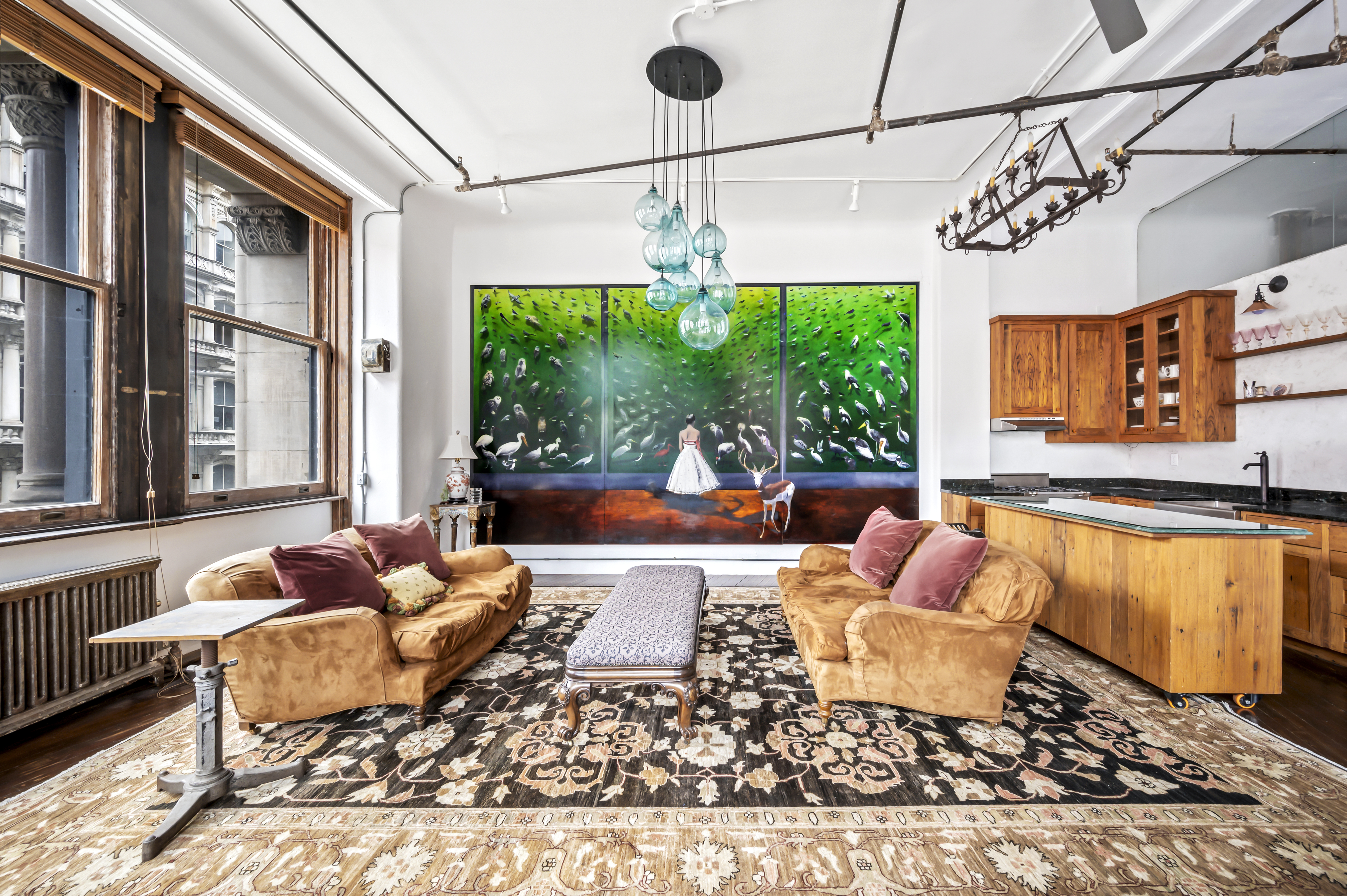 a living room with lots of furniture and a chandelier