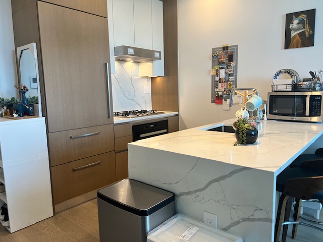 a kitchen with sink cabinets and appliances