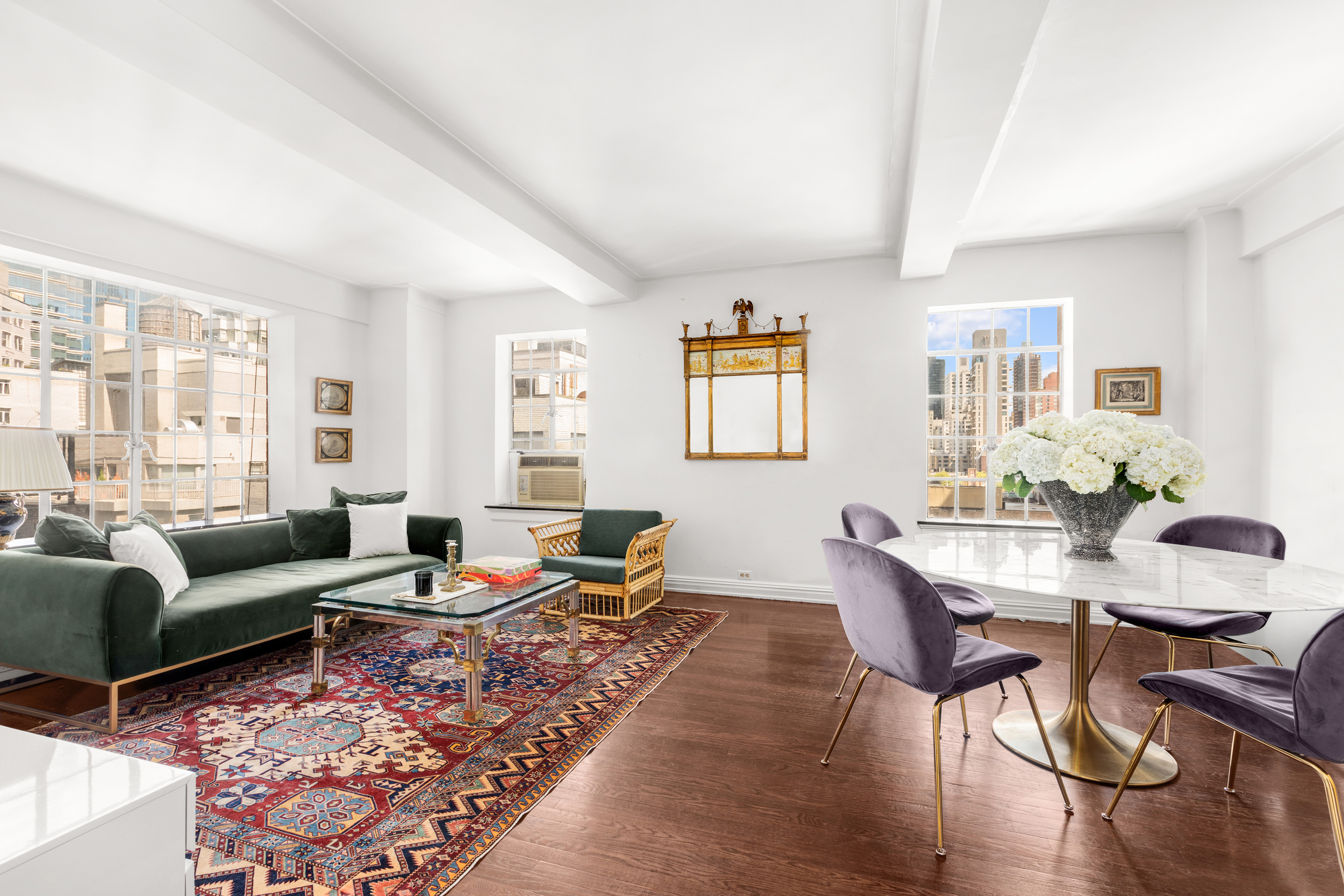 a living room with furniture wooden floor and a window