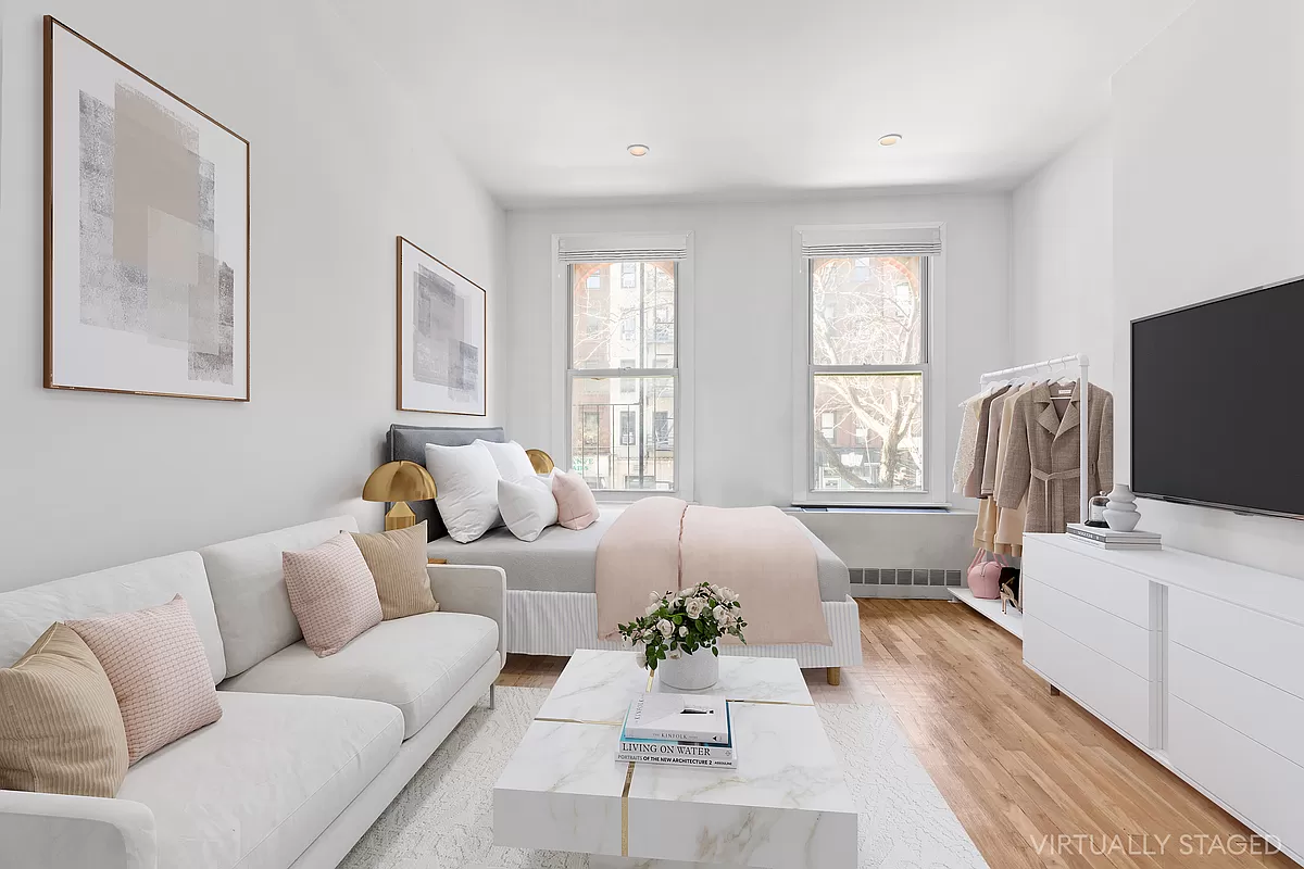 a living room with furniture a flat screen tv and a window