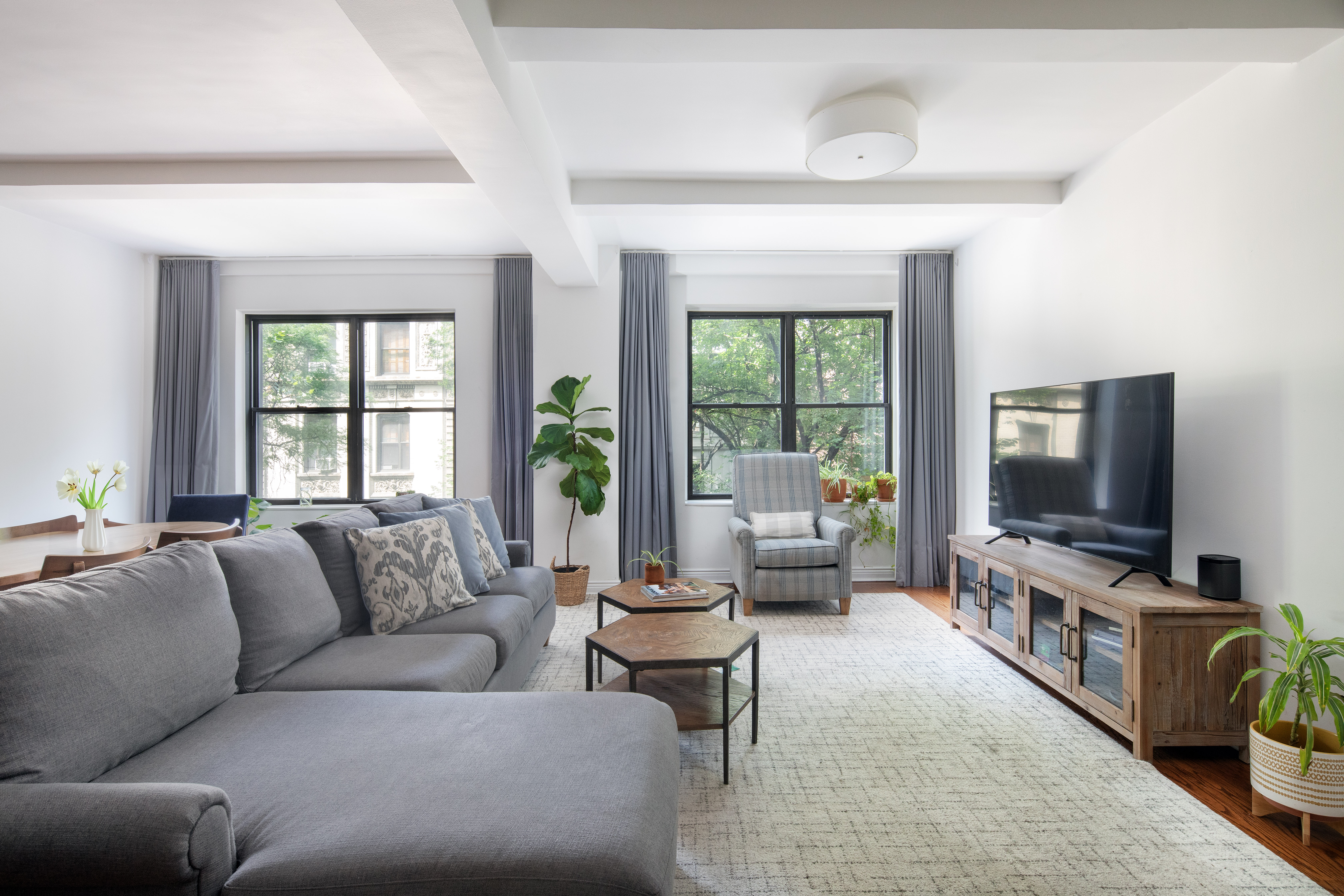 a living room with furniture and a flat screen tv