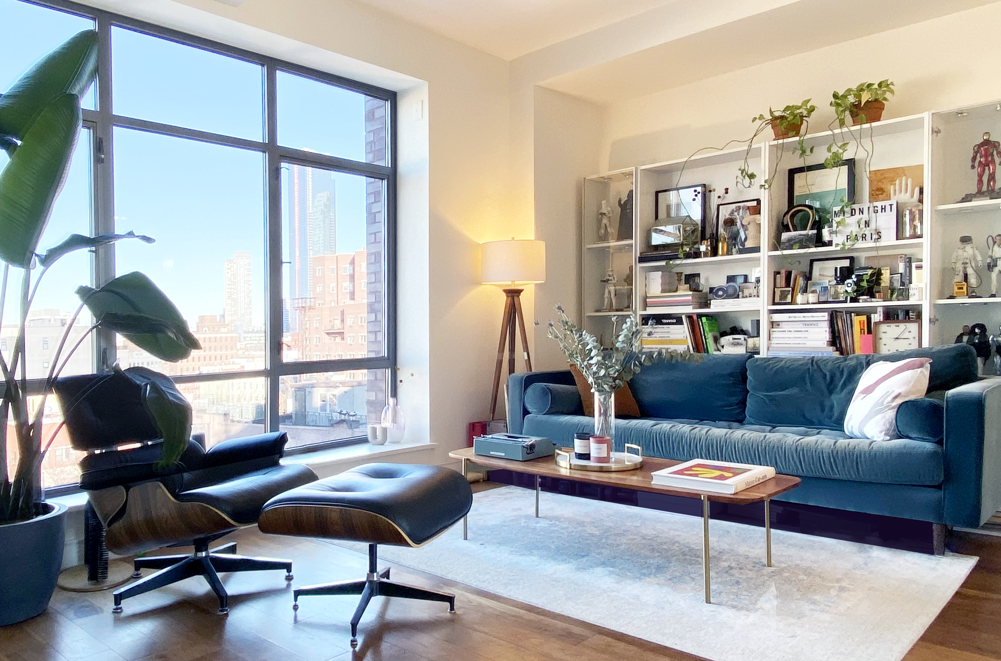 a living room with furniture a rug and a large window