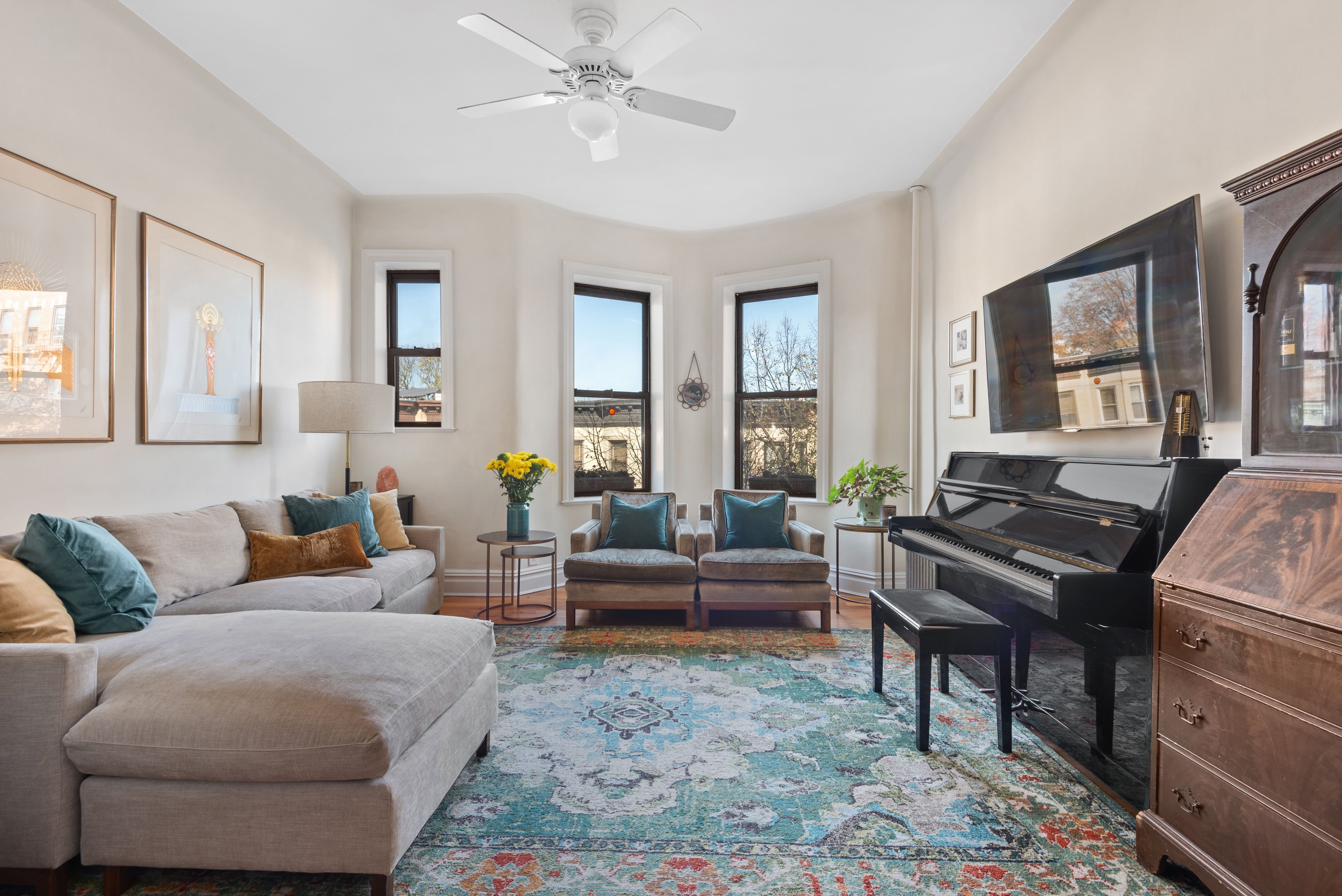 a living room with furniture and a piano