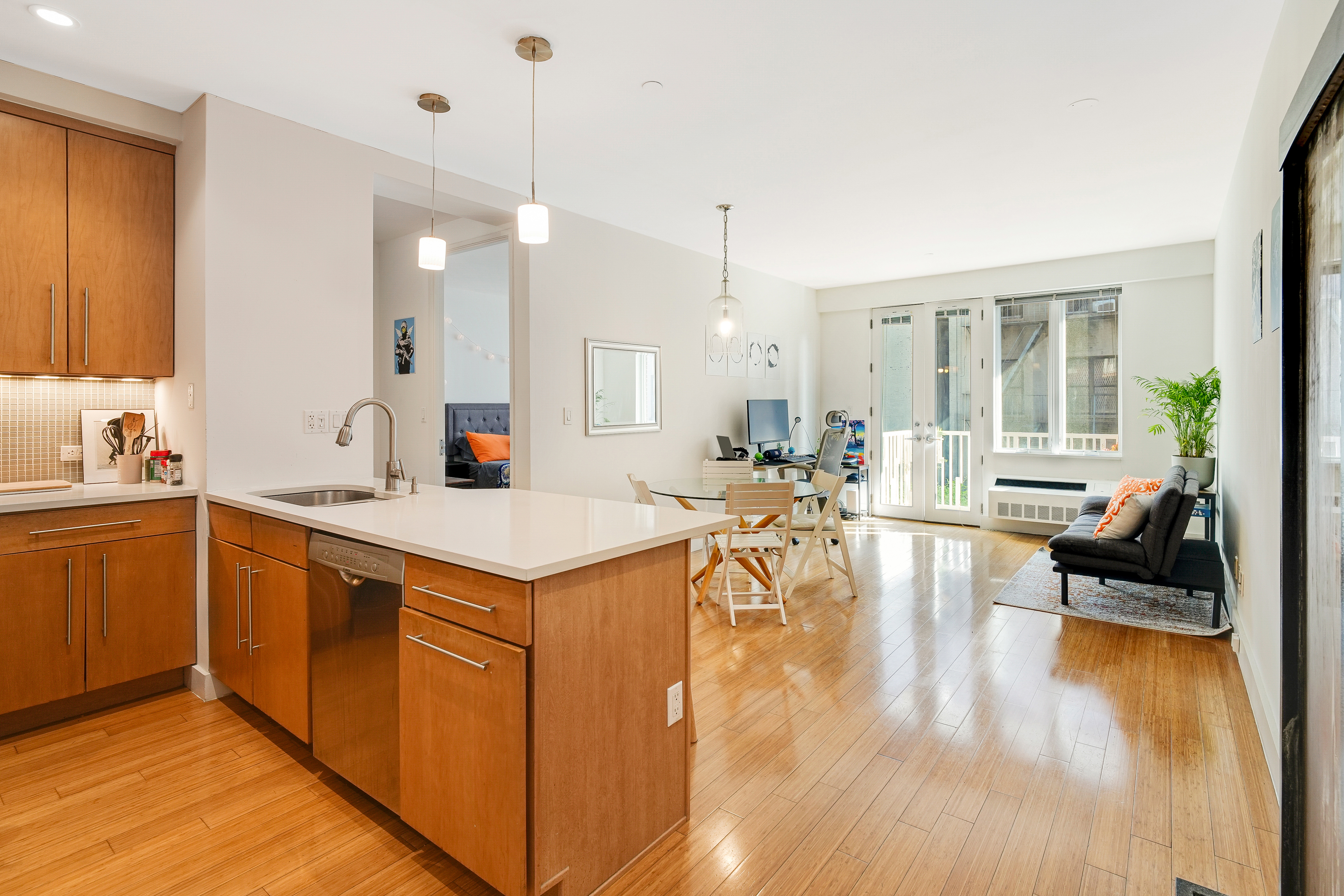 a large kitchen with kitchen island a island a sink a stove and wooden floor