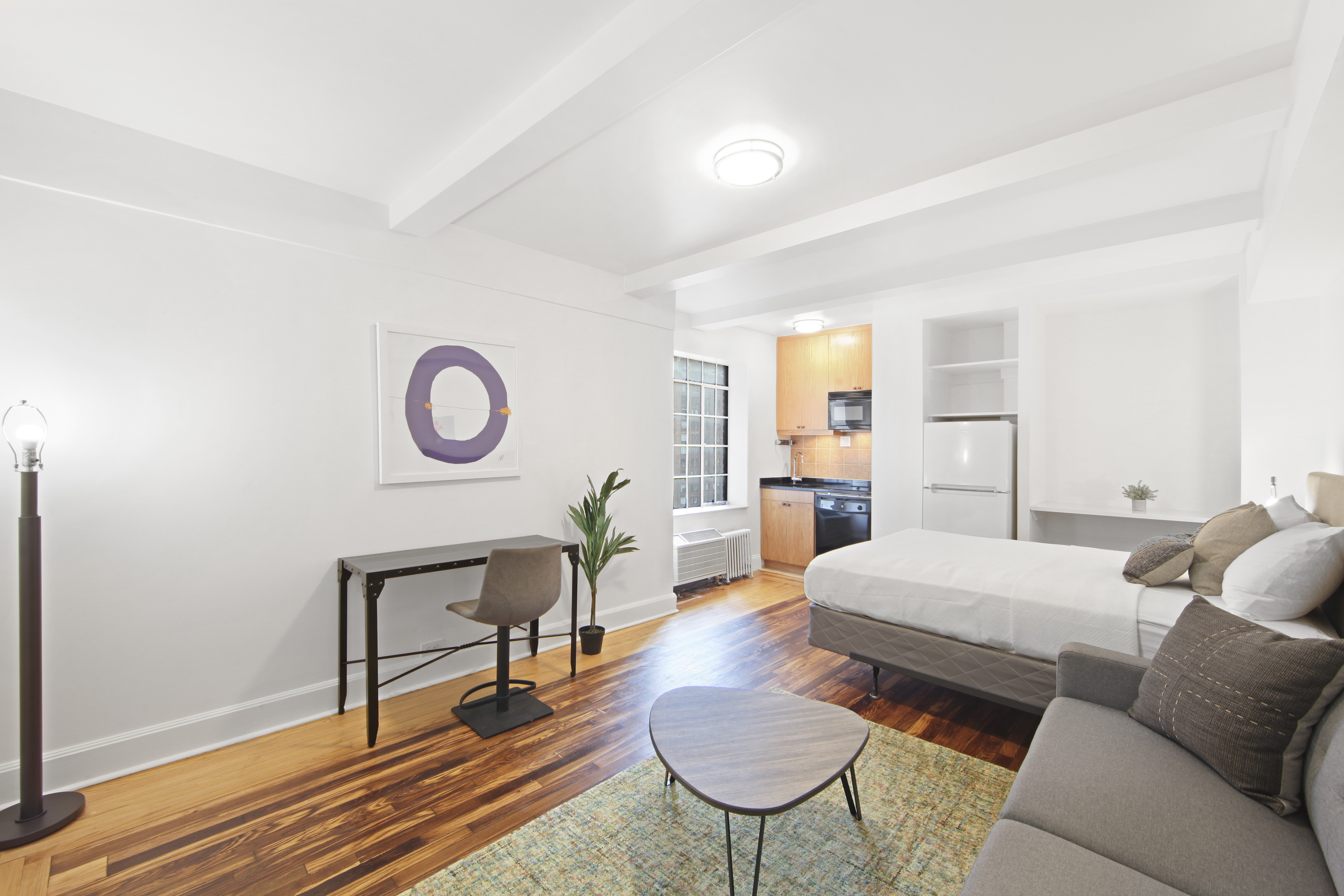 a living room with furniture and a dining table