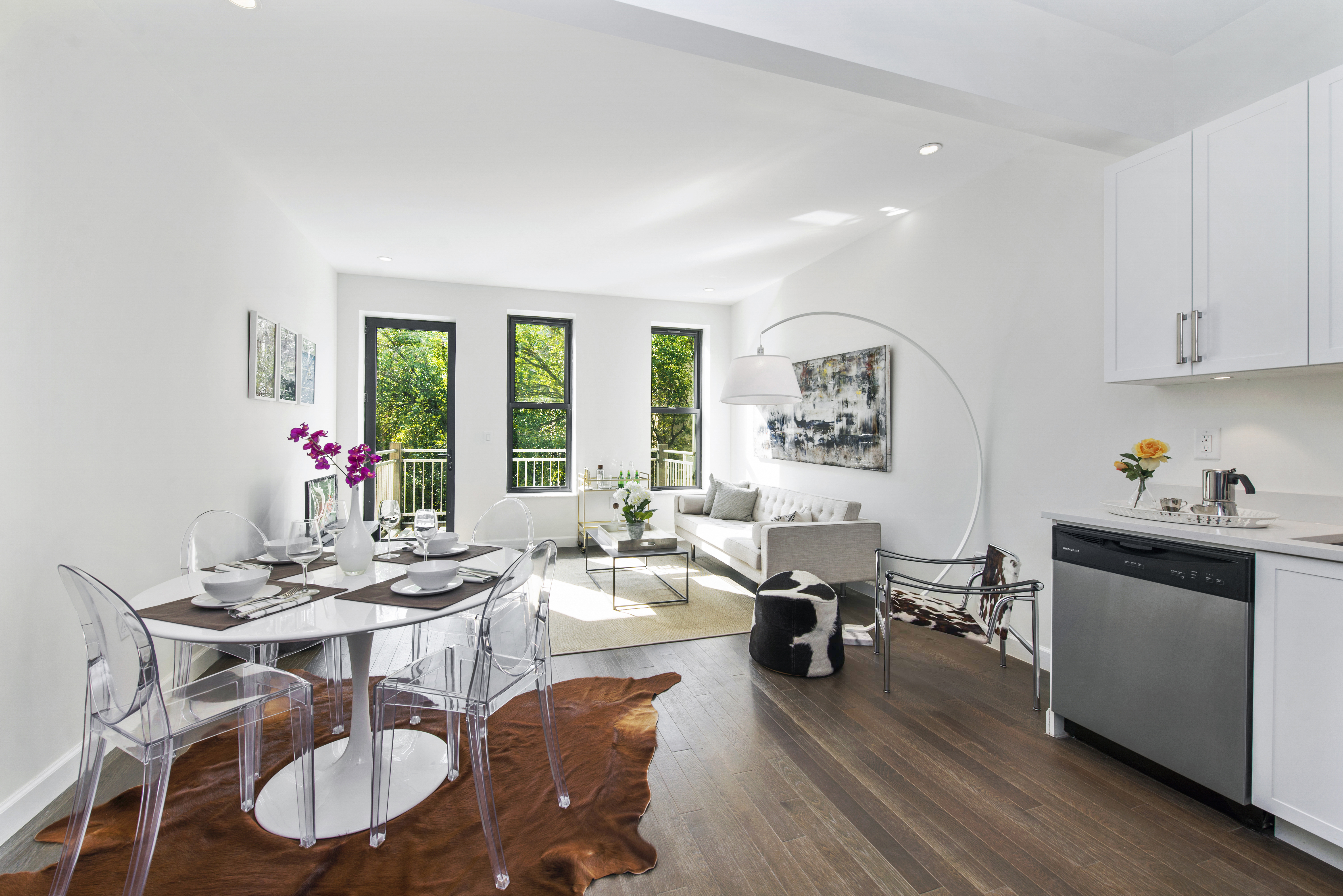 a living room with furniture dining table and a large window