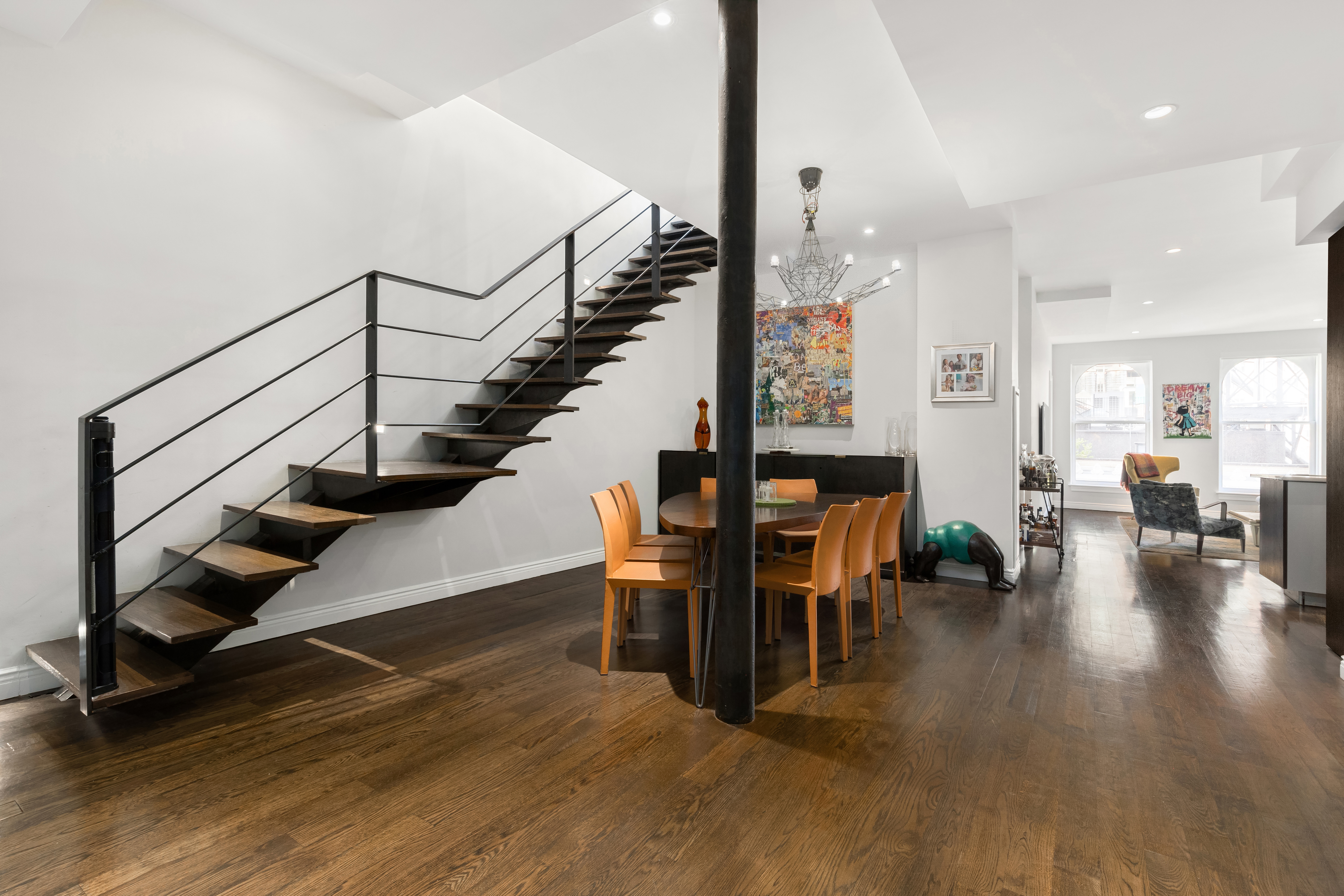 a view of entryway and hall with wooden floor