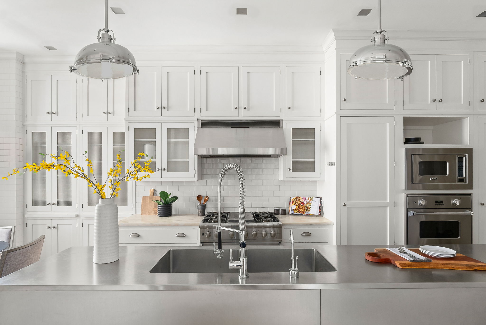 a kitchen with stainless steel appliances granite countertop a refrigerator and a stove top oven