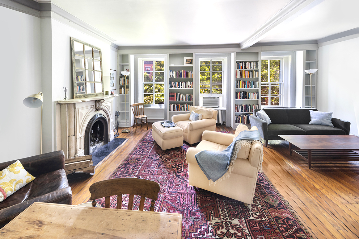 a living room with furniture fireplace and flat screen tv