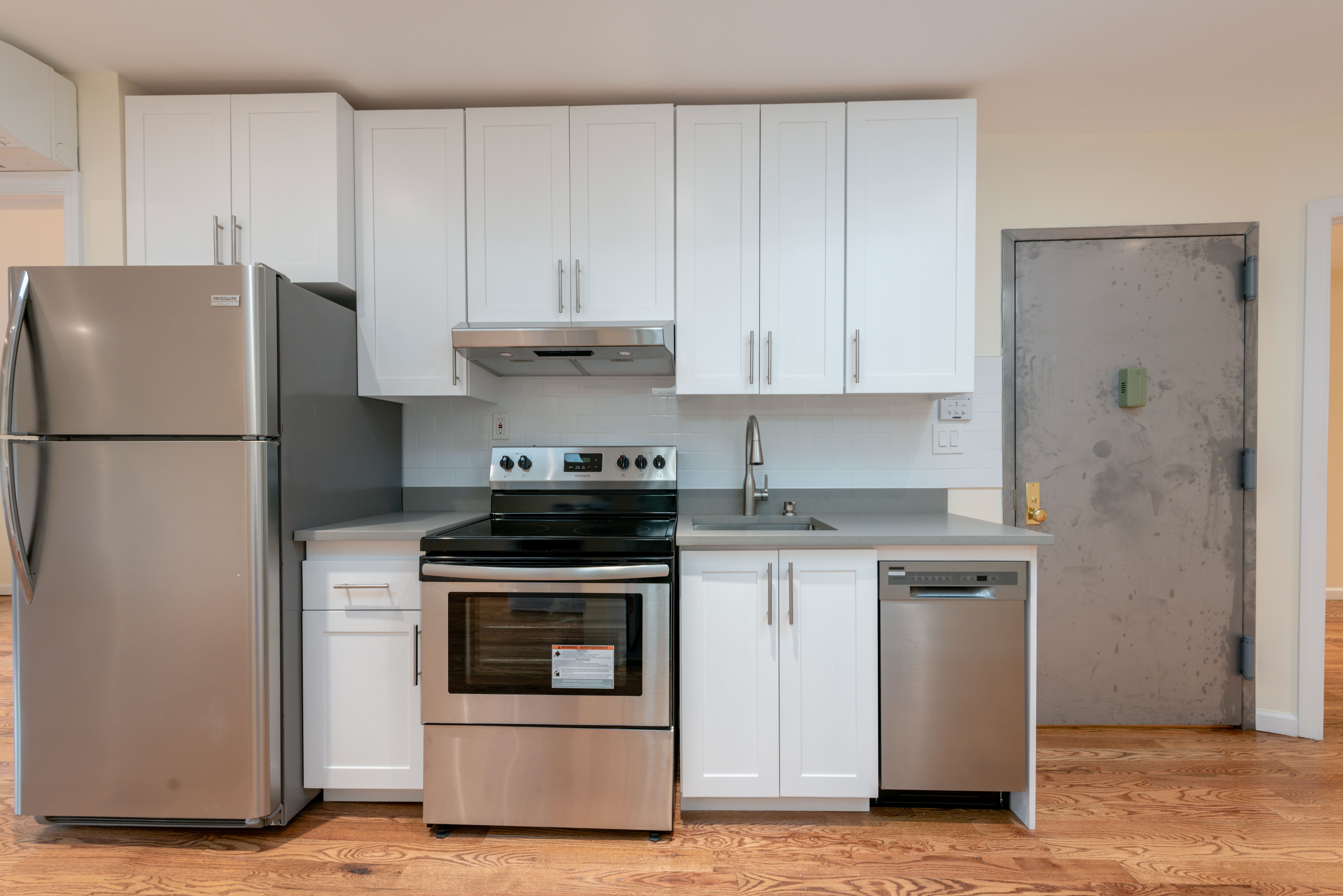 a kitchen with a stove and a refrigerator